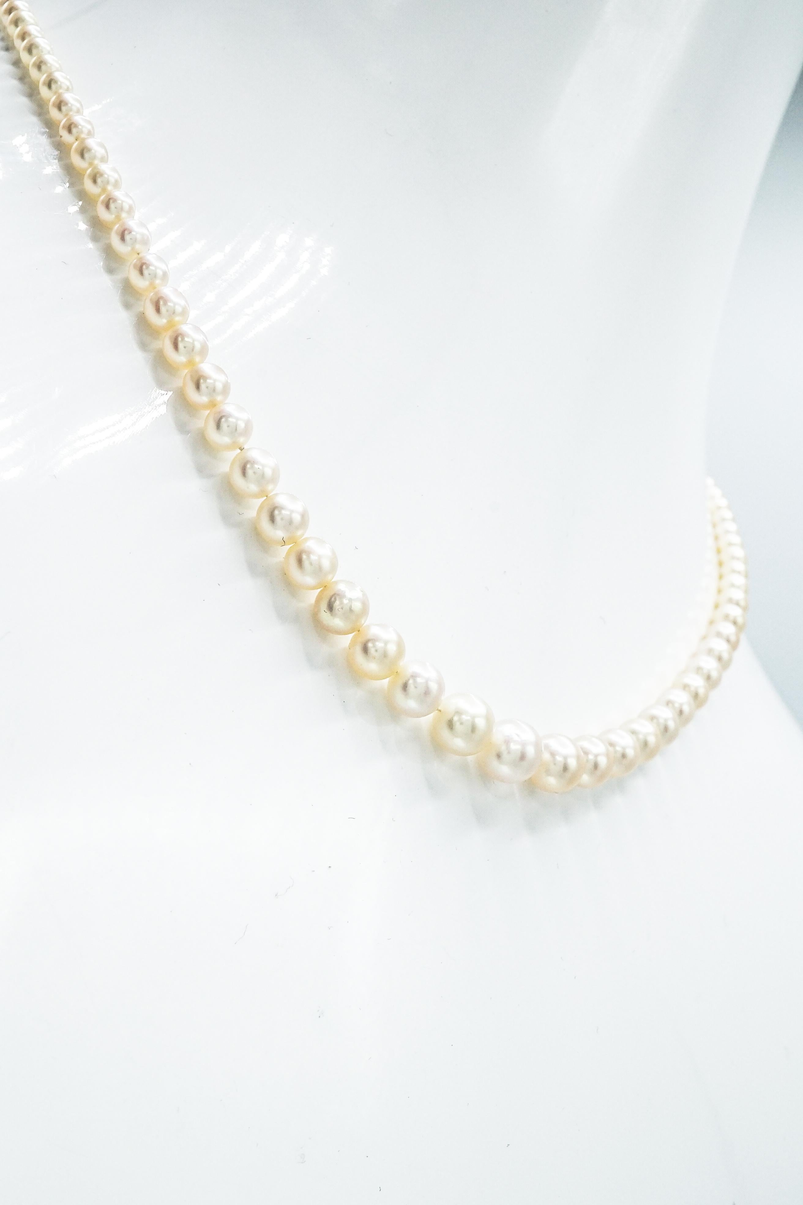Composed of 104 natural and  2 cultured pearls approximately 7.75 to 3.22 mm., completed by a platinum clasps centering one marquise-shaped diamond approximately .90 ct. Length 18 1/2 inches. 