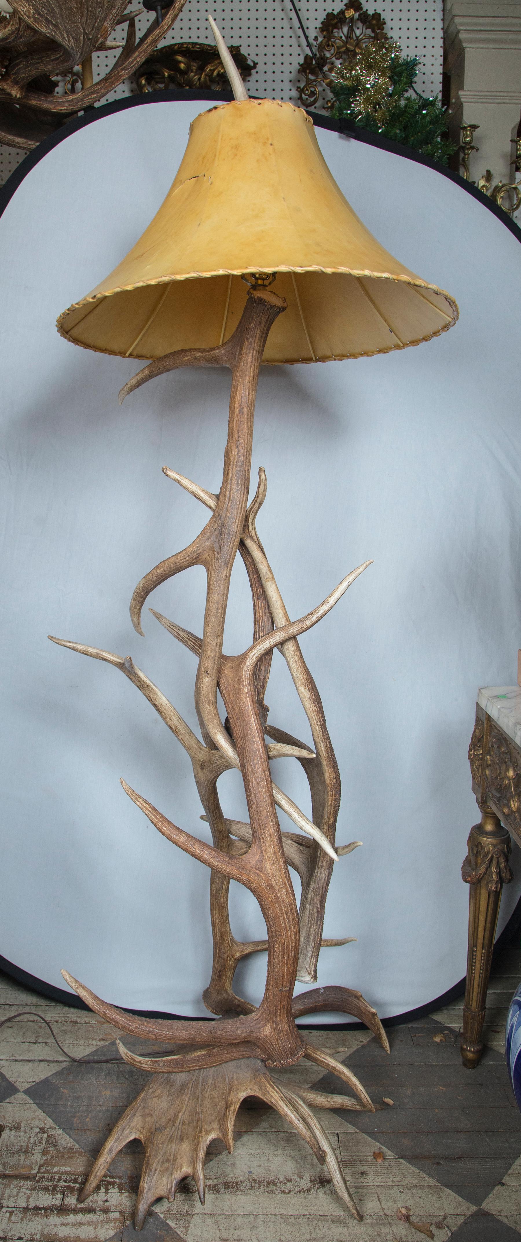 Made of intertwined elk and moose antler. Complete with a parchment (?) shade. The shade does have a slit in it. The height of 80 includes to the tip of the finial.