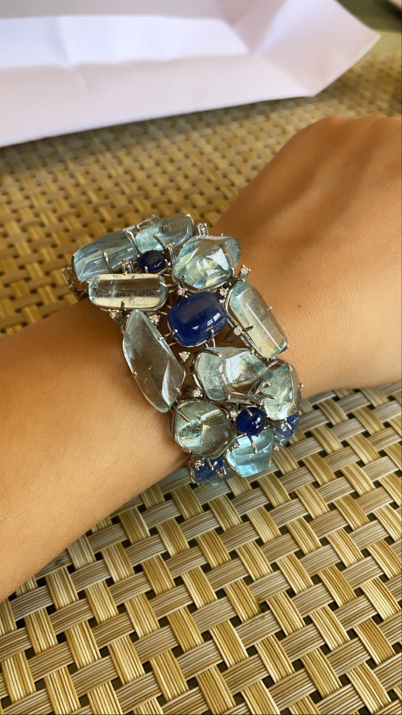 A gorgeous and modern bracelet set in 18k white gold with Natural aquamarine cabs and natural blue sapphire cabs with diamonds. The aquamarine weight is 149.15 carats and blue sapphire weight is 35.79 carats, diamond weight is .77 carats . The net