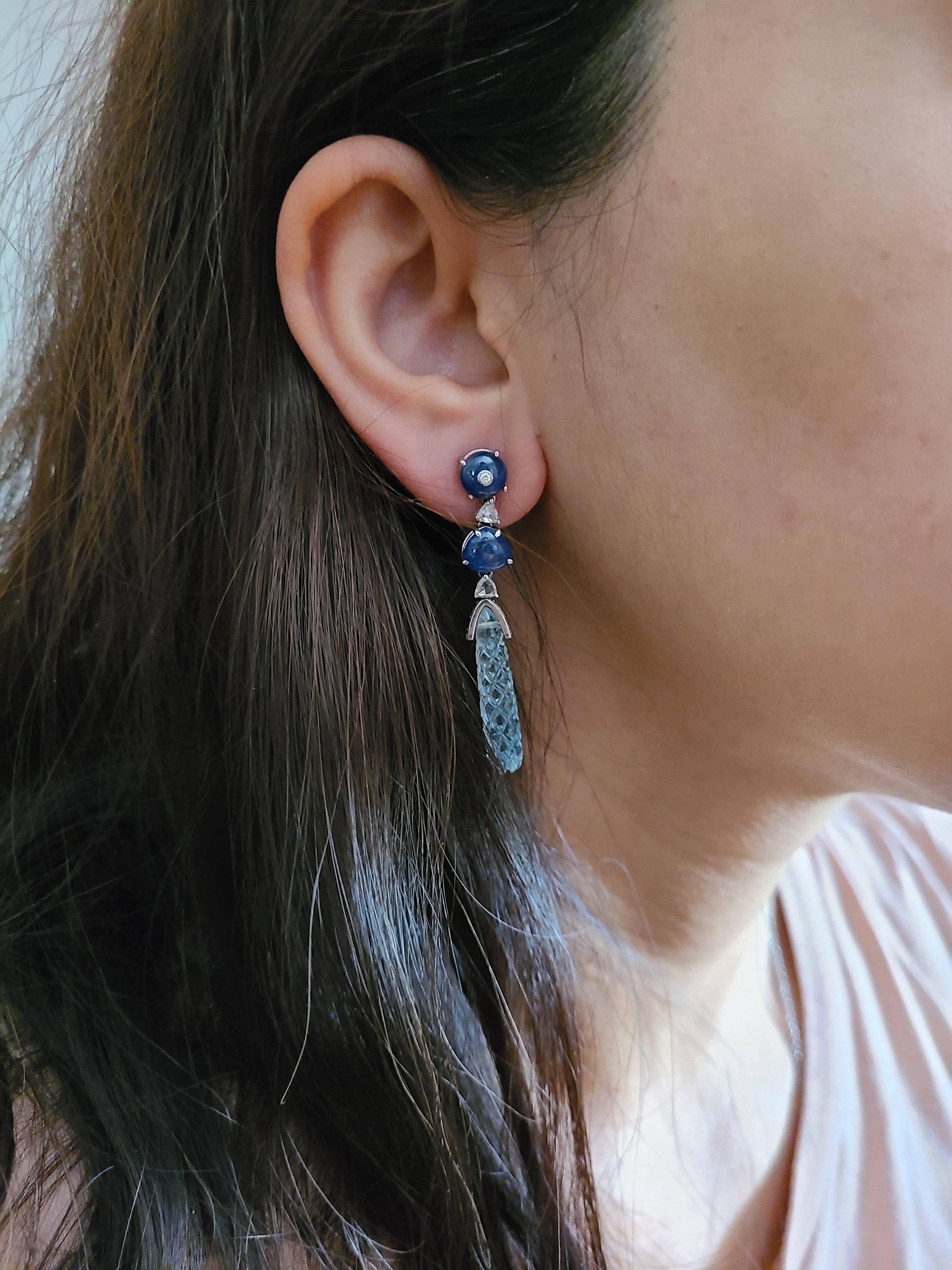 A beautiful and elegant set of earrings set in 18k white gold with natural aquamarine , blue sapphire and diamonds. The aquamarine weight is 12.06 carats , blue sapphire weight is 8.57 carats and diamond weight is 1.455 carats. The earrings