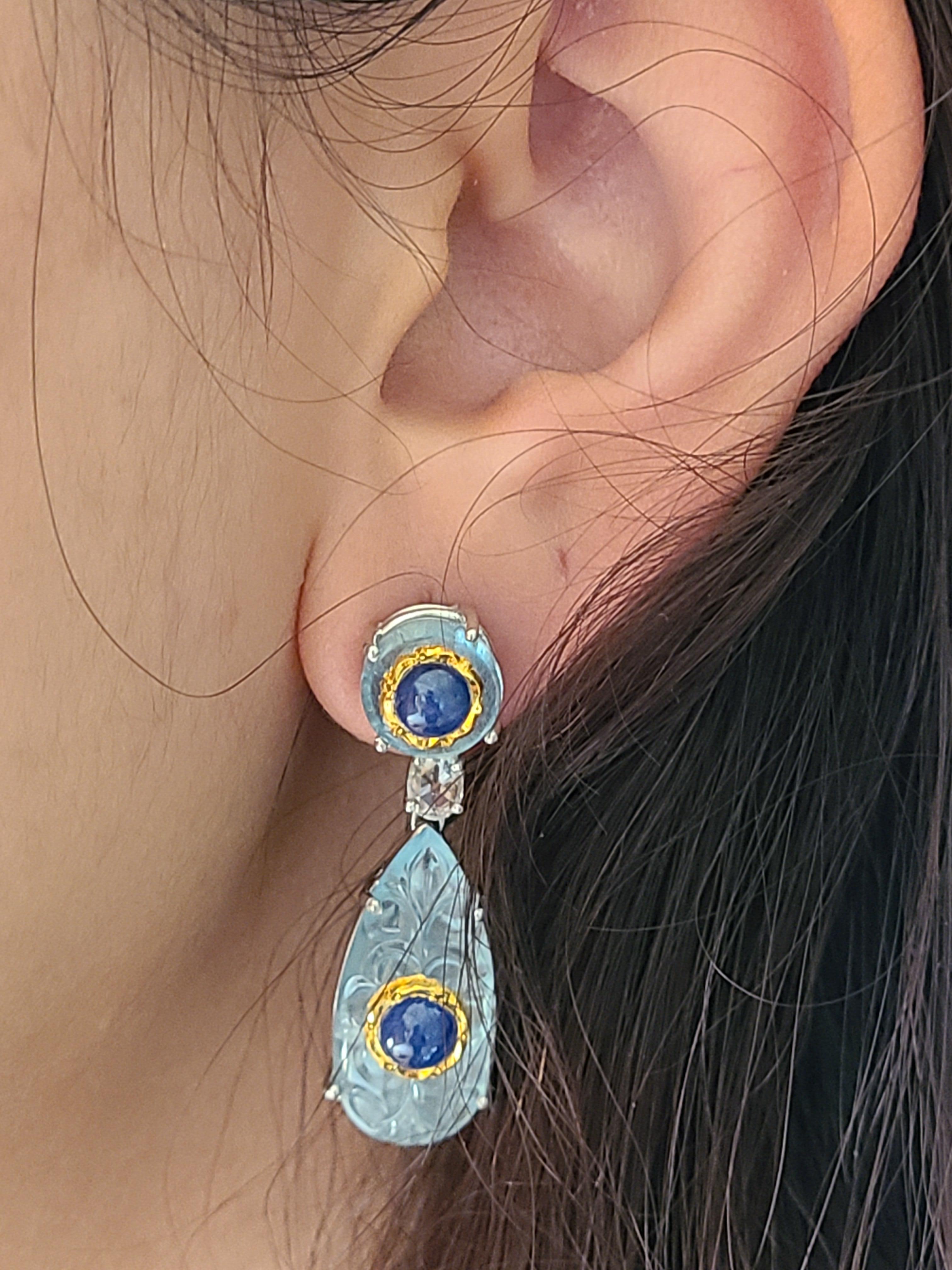 A beautiful and modern set of earrings set in 18k white gold with aquamarine and blue sapphire with rose cut diamonds. The aquamarine and blue sapphire weight is 34.02 carats (Blue sapphire is set inside the aquamarine with 24k gold also known as