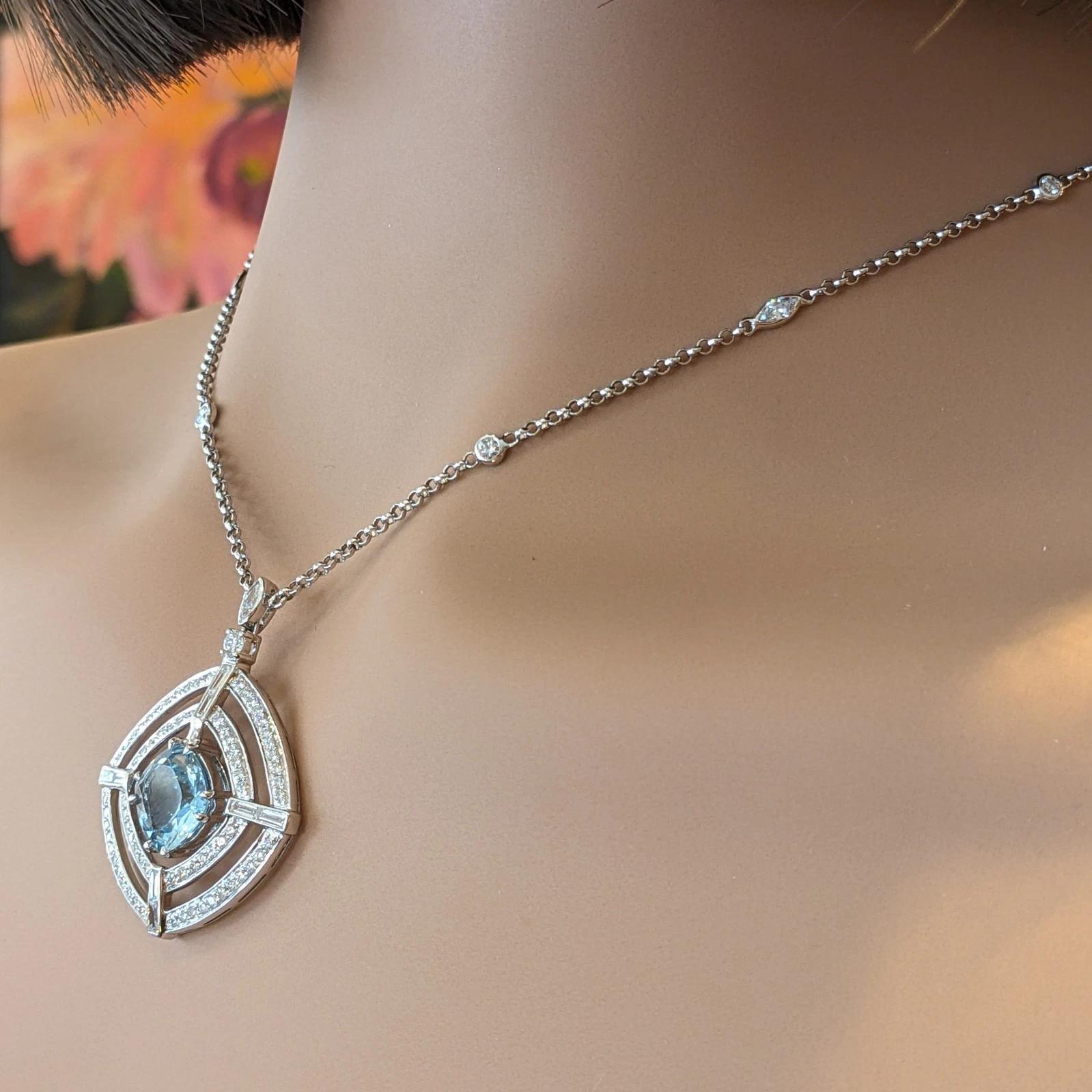 Natural Aquamarine and Diamond Pendant Necklace in 18k White Gold

Natural Aquamarine and Diamond Pendant Necklace features a Cushion shaped Pendant with Aquamarine in the center surrounded by two bezels of Round Brilliant Diamonds and Baguette