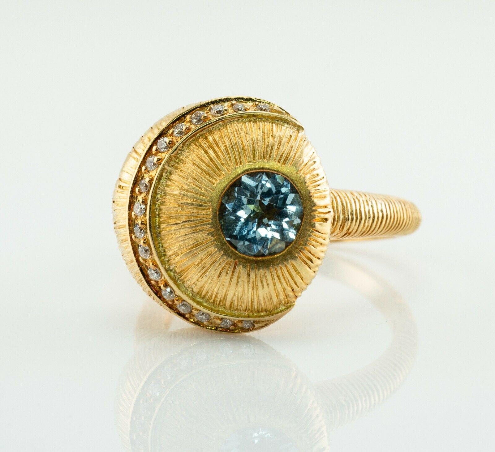 This spectacular vintage ring is finely crafted in solid 18K Yellow Gold and set with natural Earth mined Aquamarine and diamonds. The round checkerboard cut aqua measures 6mm (.75 carat). Seventeen round brilliant cut diamonds are VS2 clarity and H