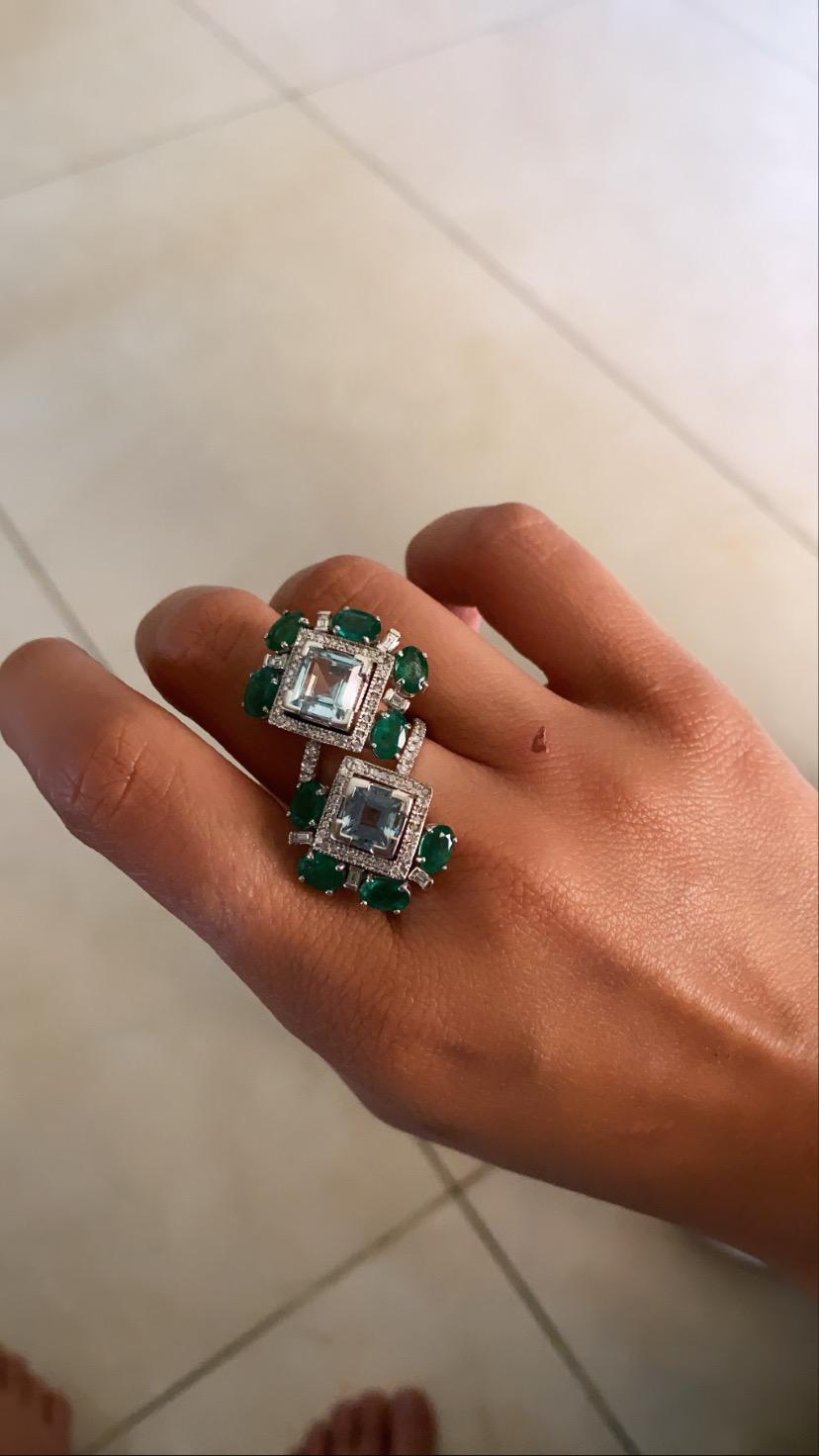 A modern and chic aquamarine and emerald ring set in 18k white gold with diamonds. The aquamarine weight is 4.14 carats, emerald weight is 3.88 carats and diamond weight is .51 carats. The net gold weight is 10.15 carats and ring dimension in cm 3.8