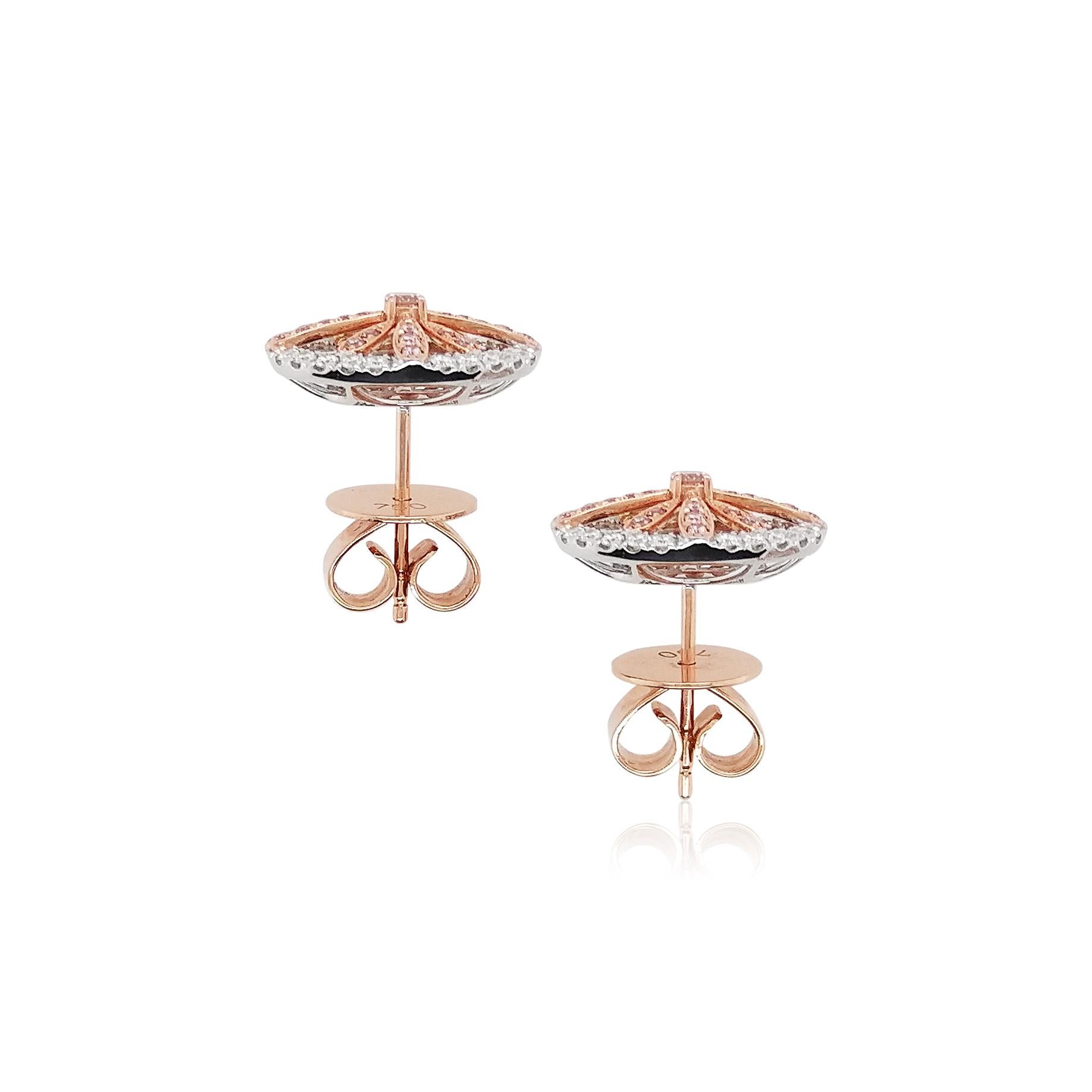 These platinum earrings offer a subtle sparkle at the forefront of their design. Featuring natural Argyle pink diamonds surrounded by a halo of scintillating white diamonds, these pretty earrings will add a touch of elegance to any outfit. Combine