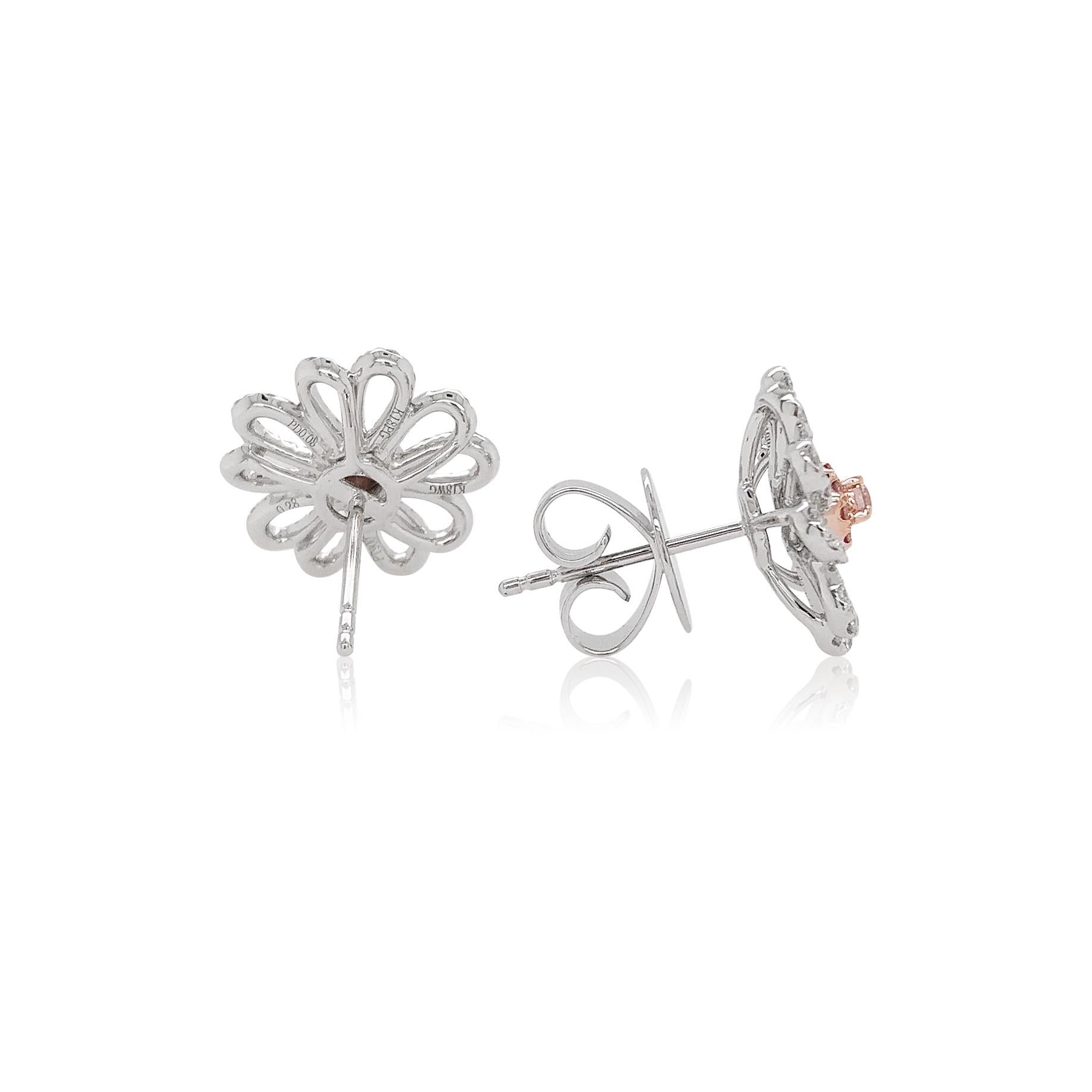 These platinum earrings offer a subtle twist on a classic design. Featuring soft Argyle pink diamonds surrounded by a floral diamond motif, these pretty earrings will add a touch of elegance to any outfit. A fantastic addition to any jewelry box,