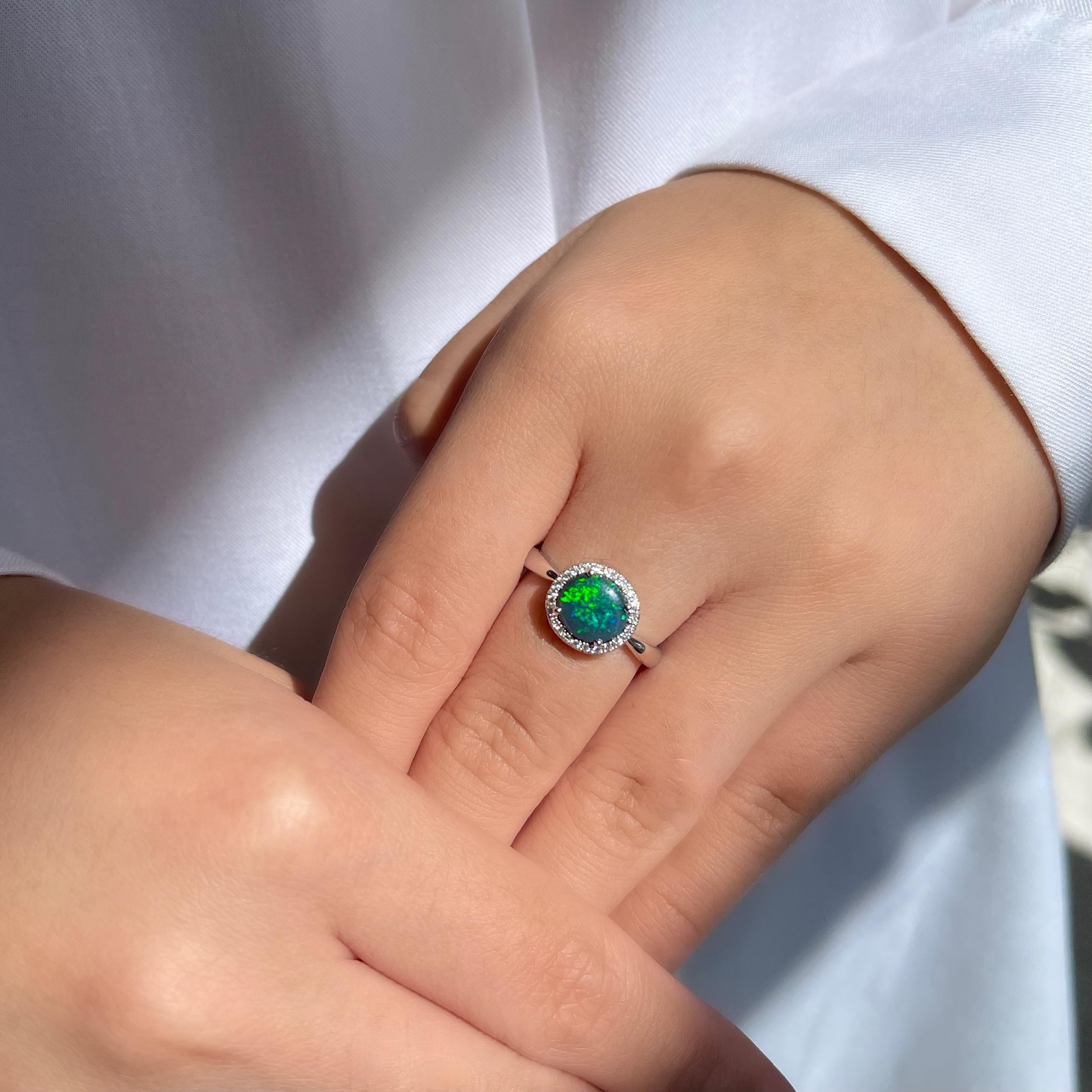 Delightful and gorgeous, the ‘I Love You’ opal ring features a wonderful black opal (1.40ct) ethically sourced from Lightning Ridge opal mines, NSW, Australia. The alluring and gracious hues of emerald and green play-of-colour of the opal is bound