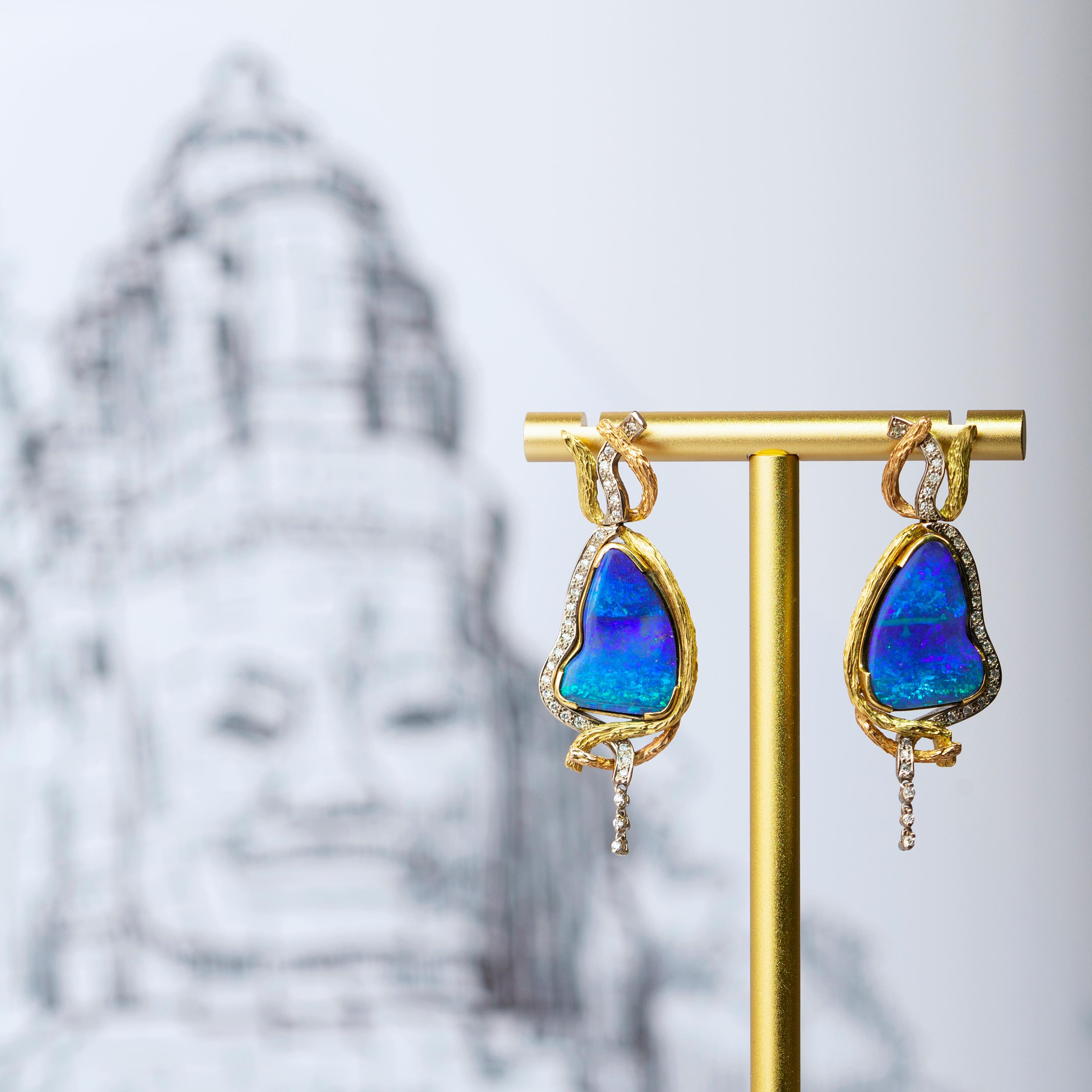 The magnificent “Ta Prohm” earrings celebrate the ancient wisdom and marvellous creativity of the revered and well-known ancient Cambodian temple. The luxurious pair of magic boulder opals (18.55ct) of this piece is sourced from Winton, Queensland