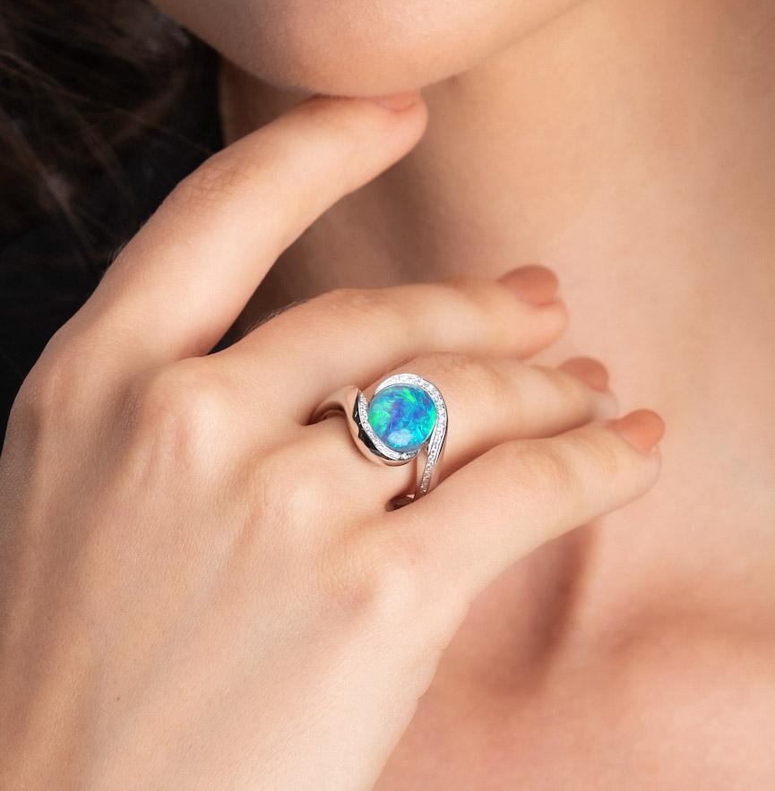 The ‘Gabriella’ opal engagement ring features a gracefully elegant black opal (3.82ct) sourced from Lightning Ridge, Australia. The unique play of colour in this ring is absolutely magnificent. Set in 18K white gold and surrounded by the beauty of