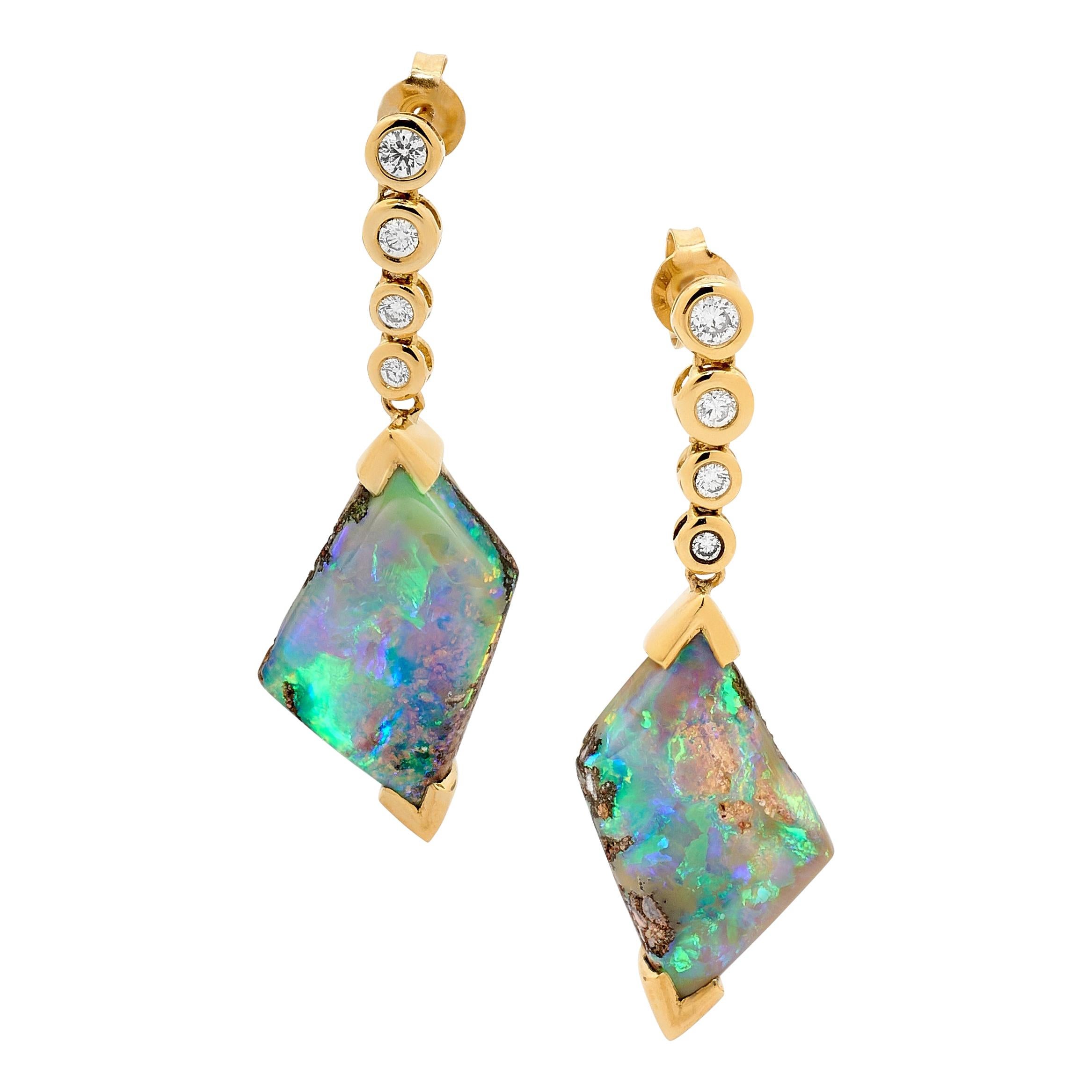 “Deep Love” opal (12.46ct) earrings tell a story of an ocean dive. Diamond air bubbles appear to lift these beautifully paired opals to the surface of an imaginary ocean. Sourced from our own mines in Jundah-Opalville and set in 18K yellow gold,