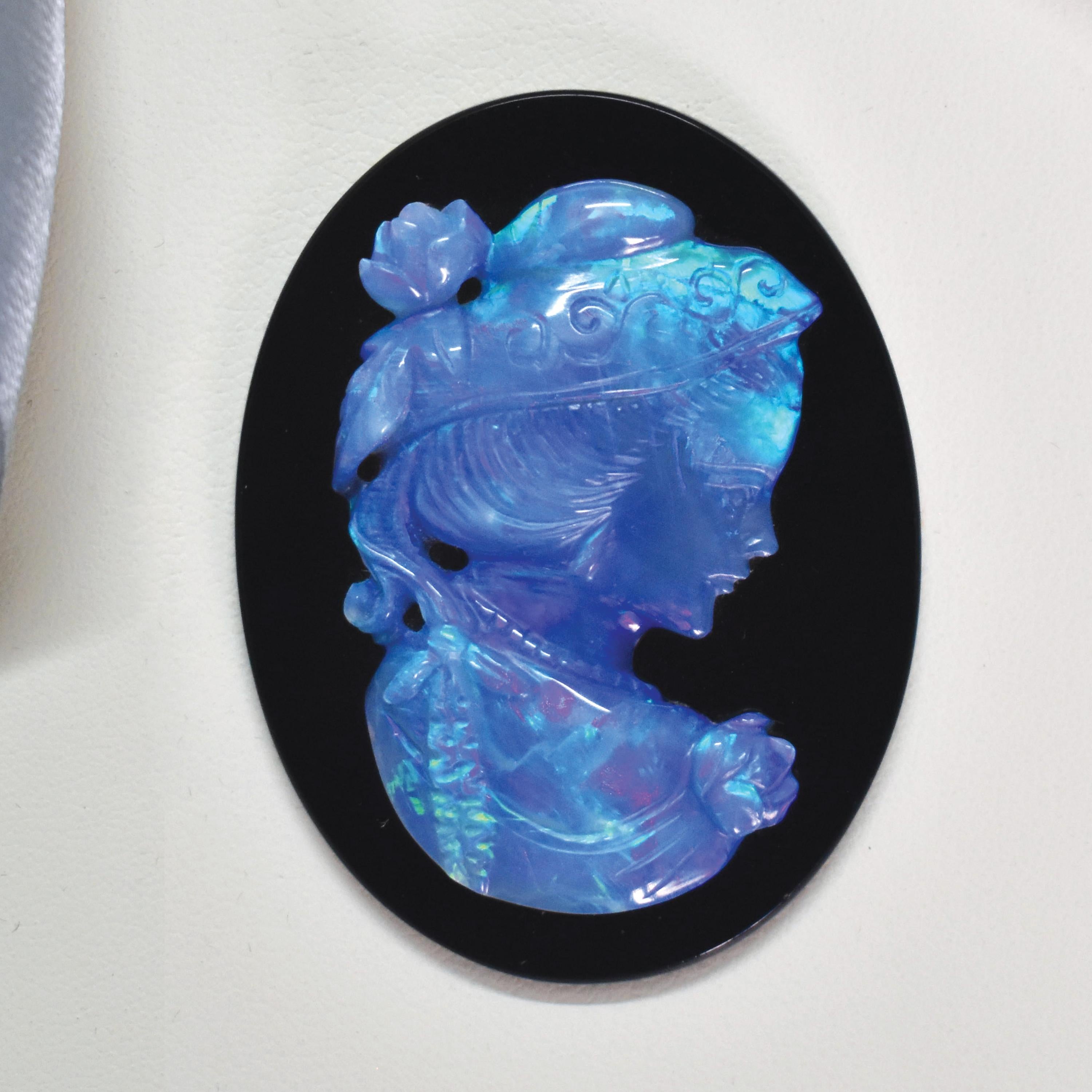 Elegant Opal Cameo on Black Onyx

This striking piece features a beautifully hand-carved Australian opal cameo set against a polished black onyx background. The opal shimmers with vivid flashes of blue, green, and violet—hallmarks of genuine