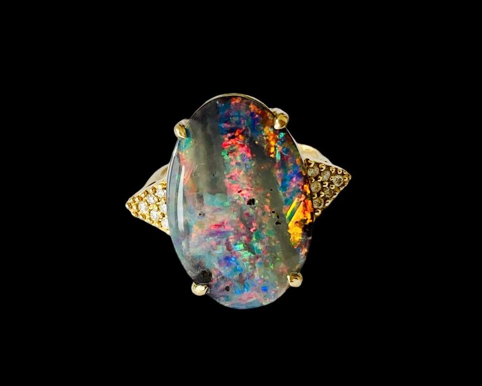This amazing Precious Opal ring will delight your heart!
It features a huge, 6.94ct Boulder Opal that was mined in Queensland, Australia.  The stone is large and measures approximately 22mm x 15mm x 4mm and is Oval shaped.  This lovely gem displays