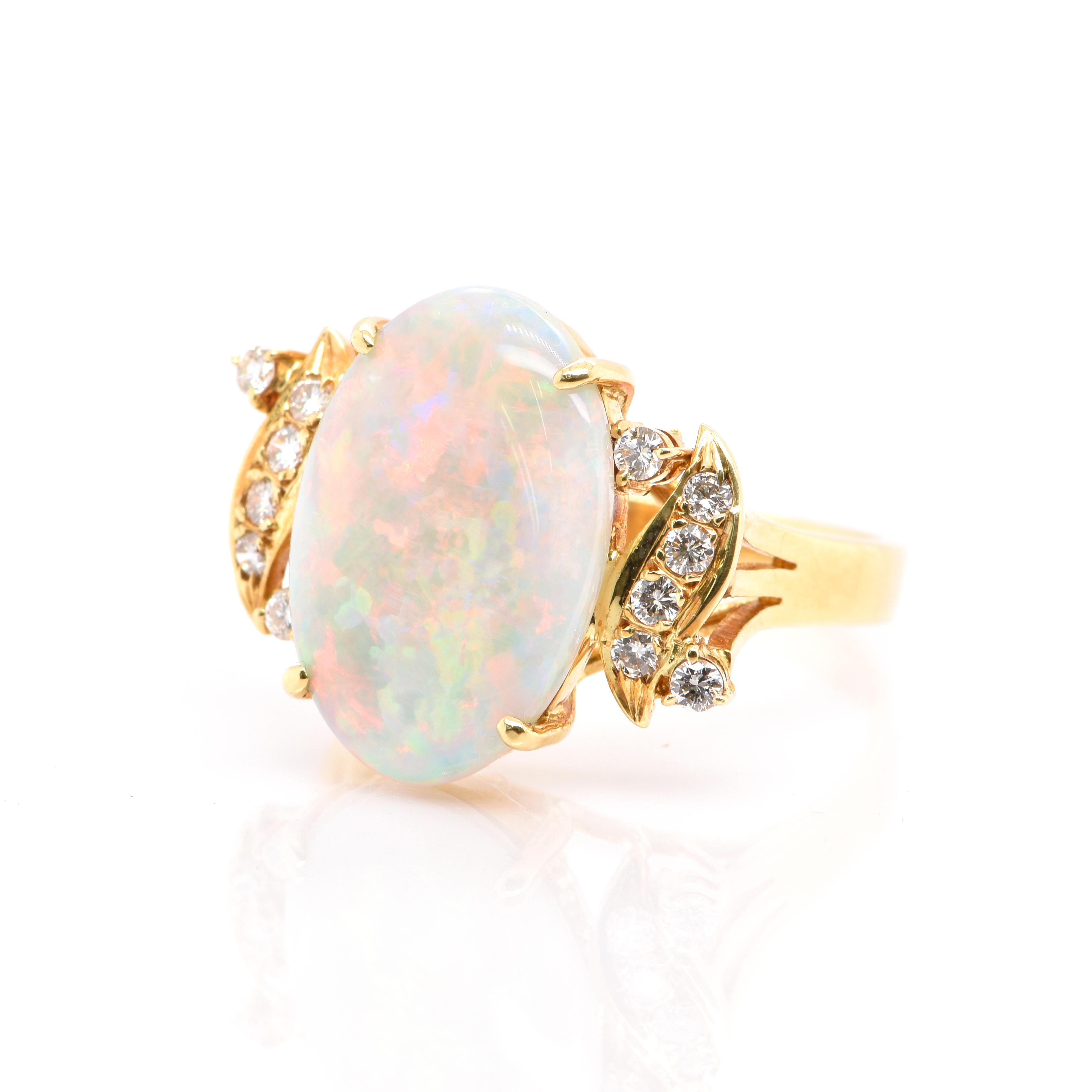 A beautiful Cocktail Ring featuring a Natural Australian White Opal and 0.25 Carats of Diamond Accents set in 18K Yellow Gold. Opals are known for exhibiting flashes of rainbow colors known as 