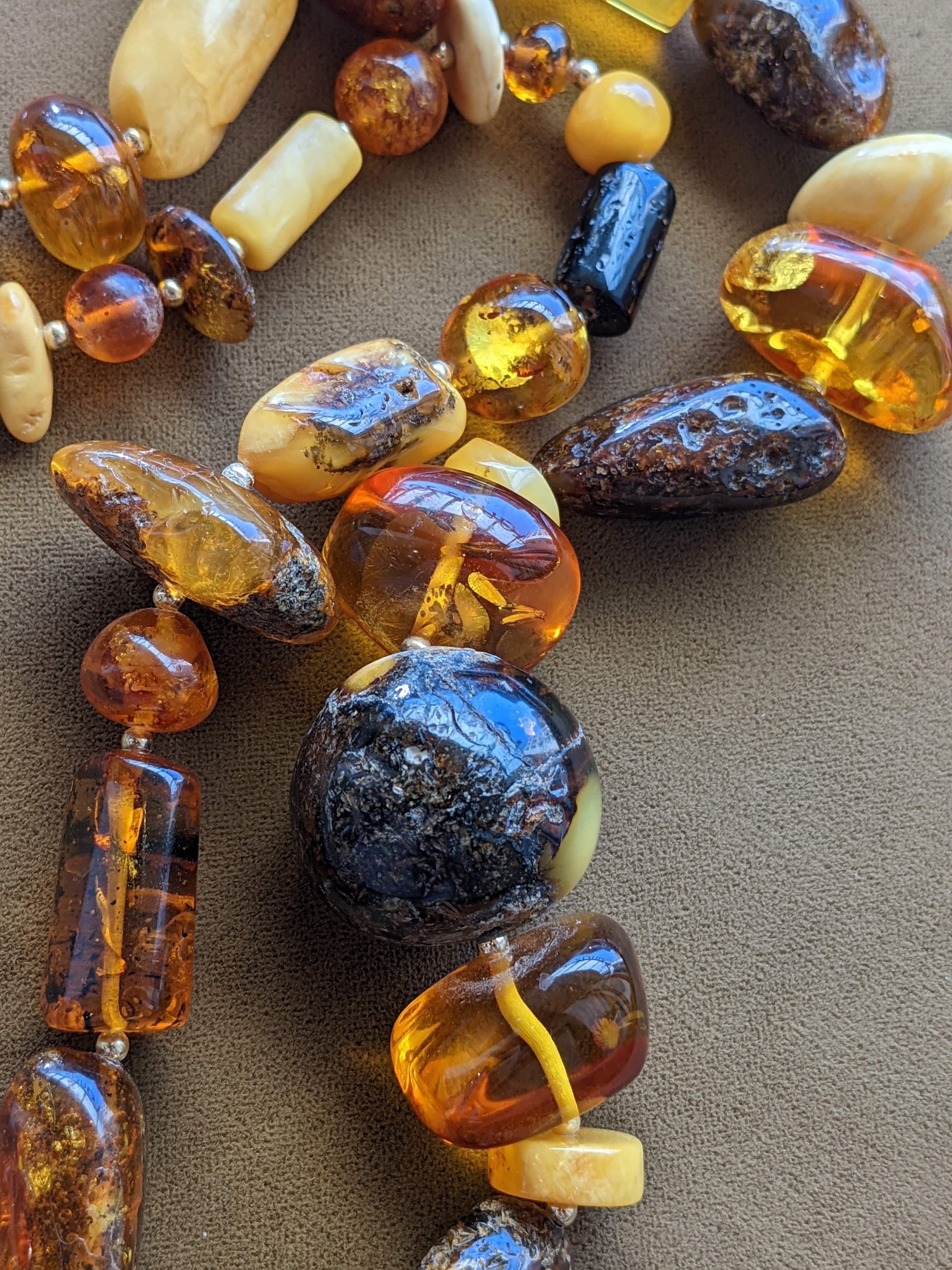 This fun and cheery necklace features a huge assortment of all natural Baltic Amber beads, all strung with small golden beads between so each is set off perfectly. There is a great mix of polished geometric shaped beads, and also lots of organically