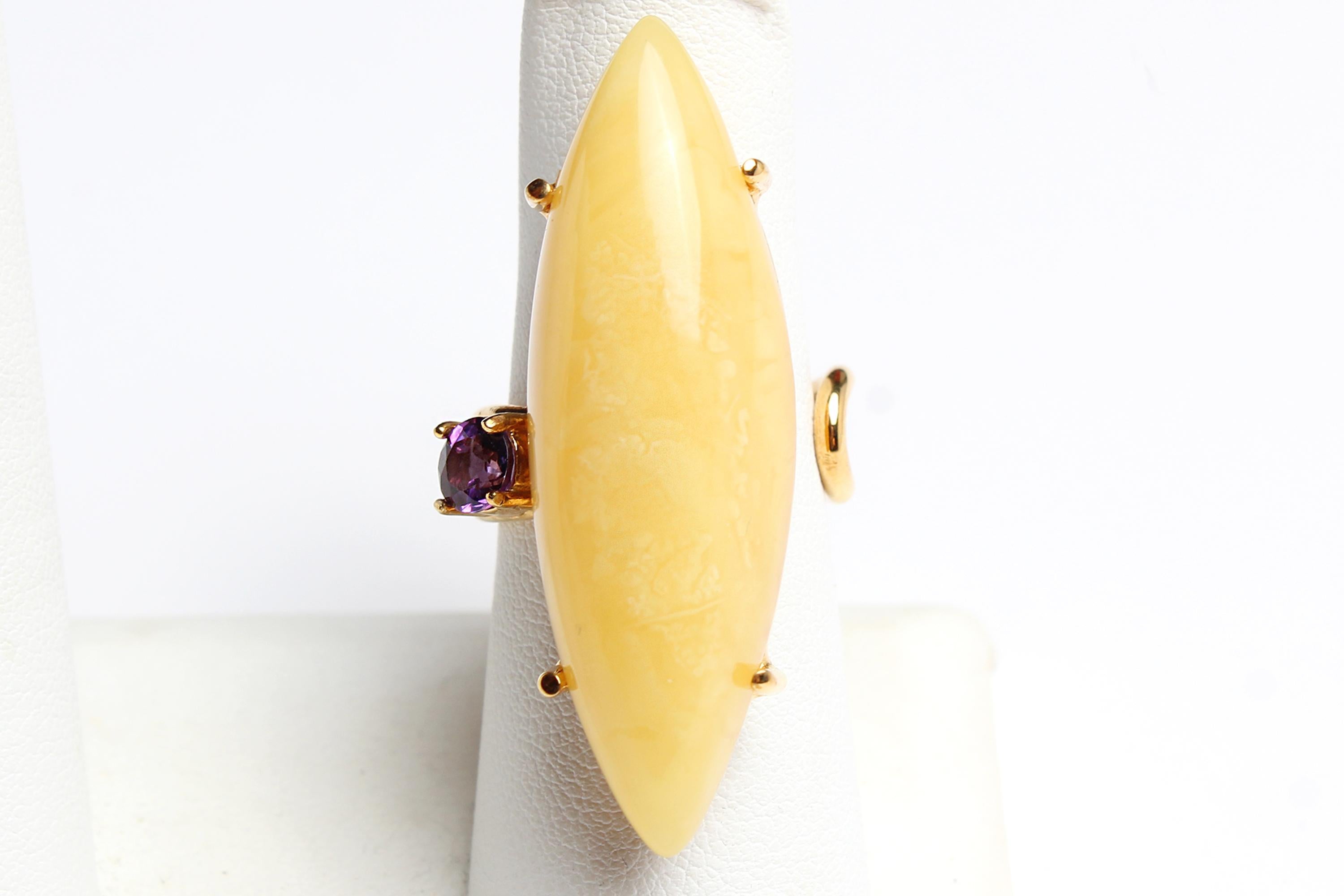 - This elegant 14K gold-plated adjustable
ring features a 925 sterling silver setting, highlighting an oblong marquise cut butterscotch amber gemstone with a stunning purple amethyst accent. A truly unique piece to add to your collection