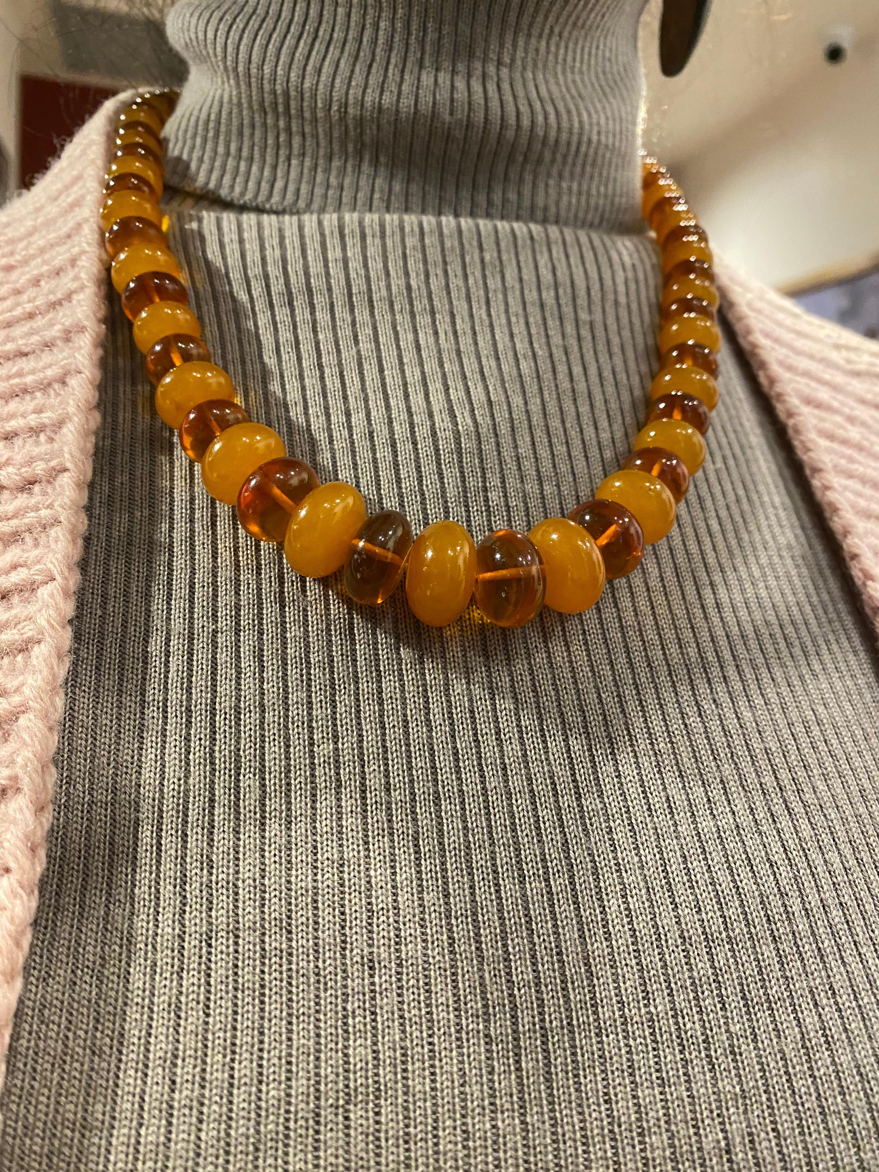 This magnificent vintage necklace
from Eastern Europe,
features 67 graduating Natural Amber
of superb natural intense Honey Colour, 
alternating with translucent beads 
ranging in size (with the largest being 20mm x 12mm & 
smallest – 5mm x 7mm),