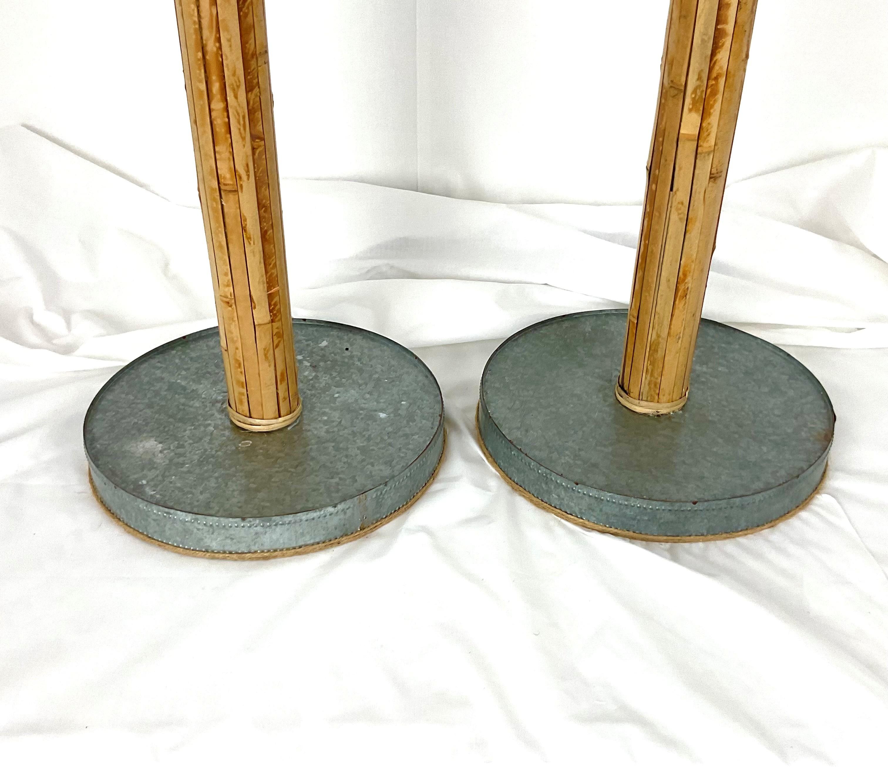 Add natural warmth and organic charm to your space with this pair of bamboo-inspired floor lamps. Each lamp features a tall bamboo-look column with a sturdy round base and brass hardware accents, complemented by dual pull chains for easy operation.