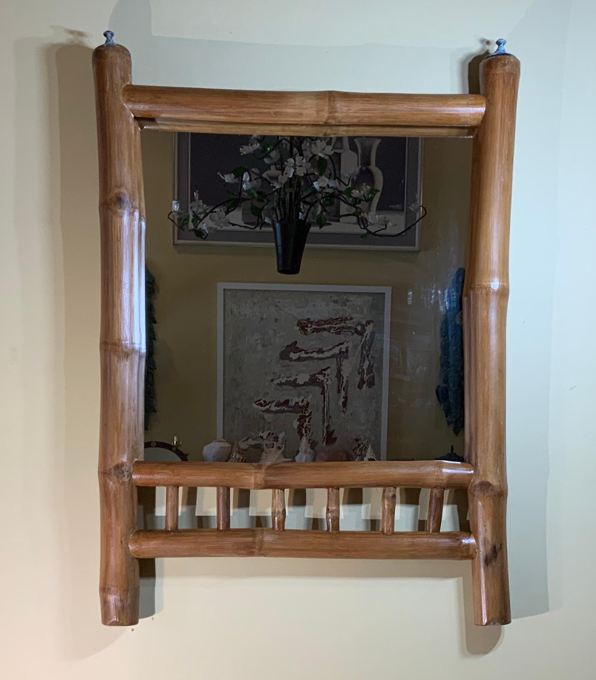 Exceptional wall hanging mirror made of thick natural bamboo, clear stain-polish ,with decorative brass finial one on each side top. Will look great at cabin or country side house.