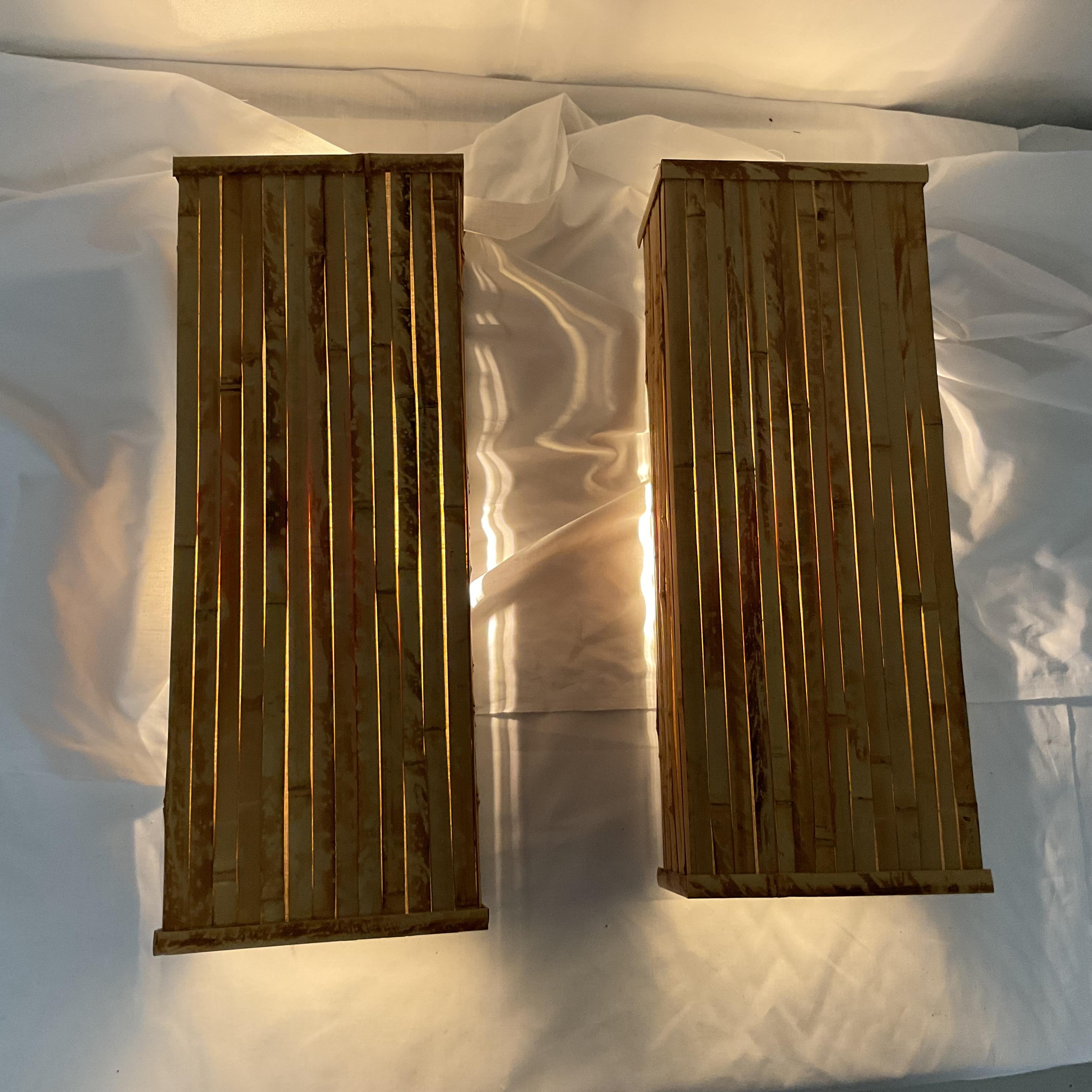 Add a warm, natural touch to your space with this beautiful pair of wall sconces. Featuring a vertical natural bamboo design in a golden honey finish, these sconces bring tropical charm and organic texture to any interior. Their rectangular shape