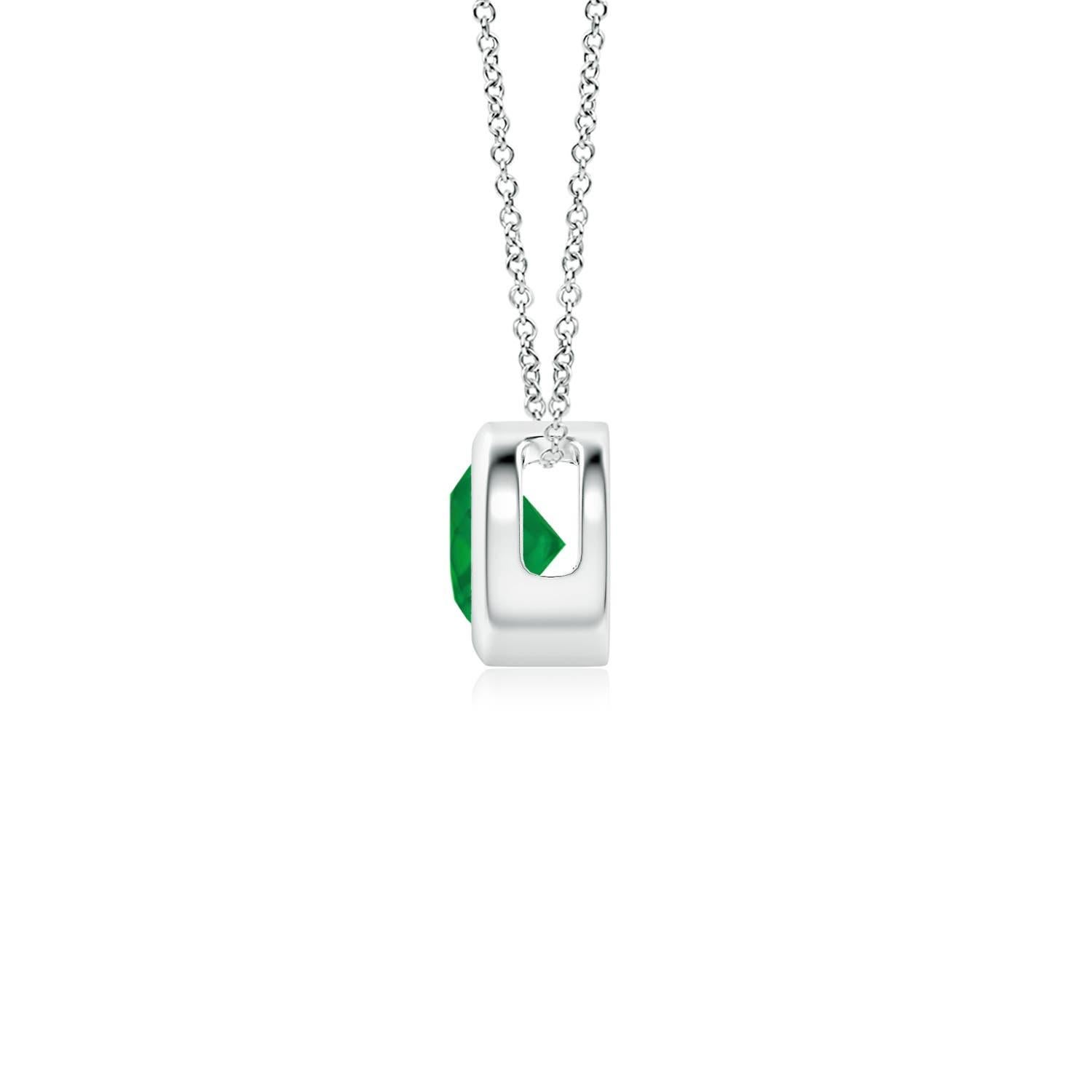 This classic solitaire emerald pendant's beautiful design makes the center stone appear like it's floating on the chain. The lush green emerald is secured in a bezel setting. Crafted in 14k white gold, this round emerald pendant is simple yet