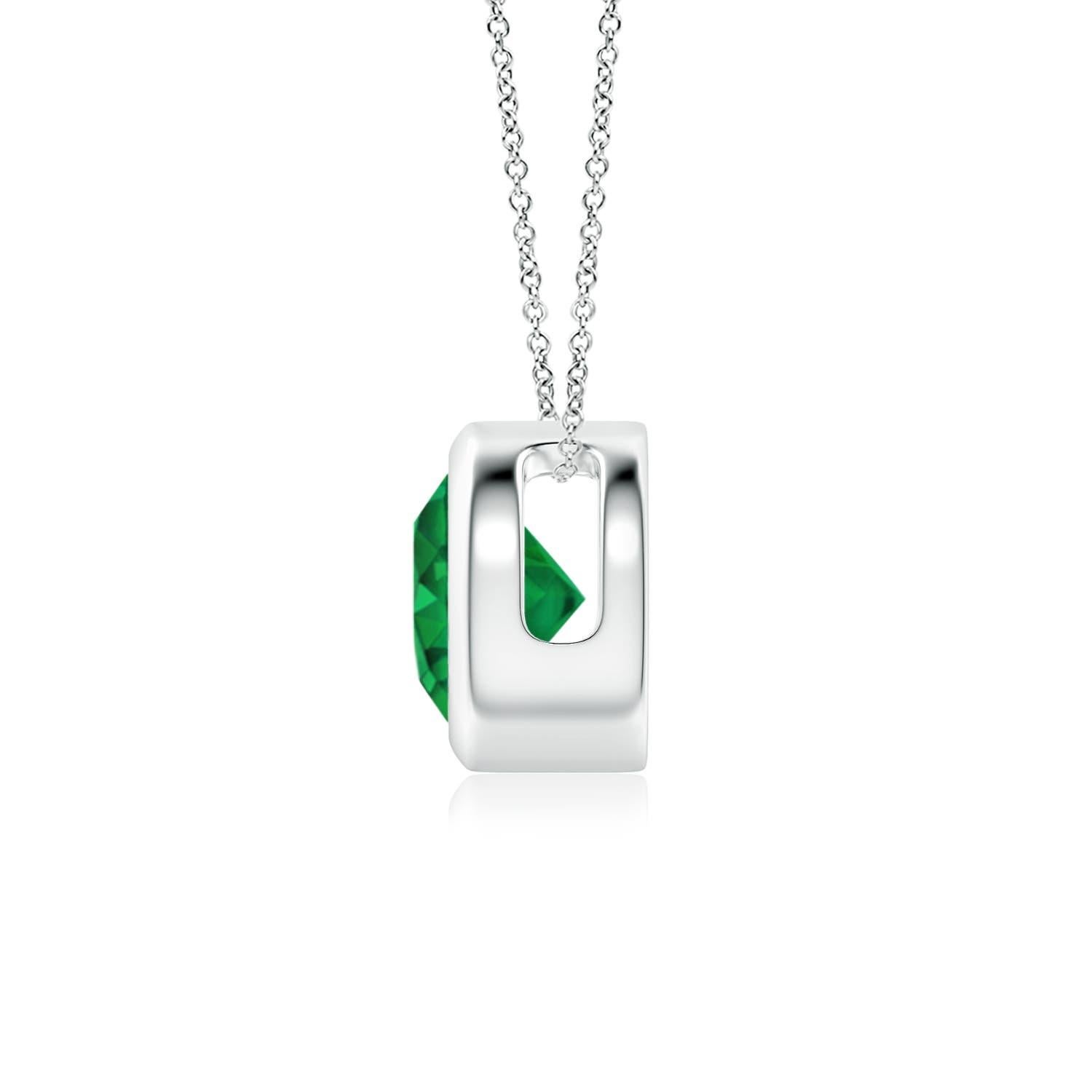 This classic solitaire emerald pendant's beautiful design makes the center stone appear like it's floating on the chain. The lush green emerald is secured in a bezel setting. Crafted in 14k white gold, this round emerald pendant is simple yet