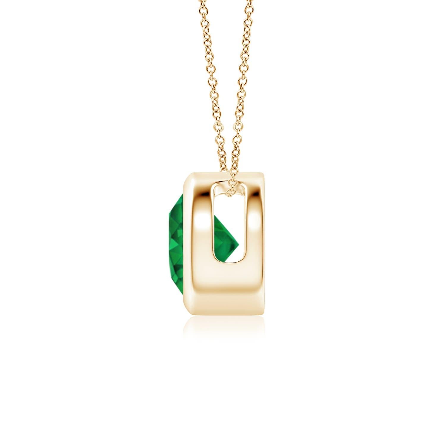 This classic solitaire emerald pendant's beautiful design makes the center stone appear like it's floating on the chain. The lush green emerald is secured in a bezel setting. Crafted in 14k yellow gold, this round emerald pendant is simple yet