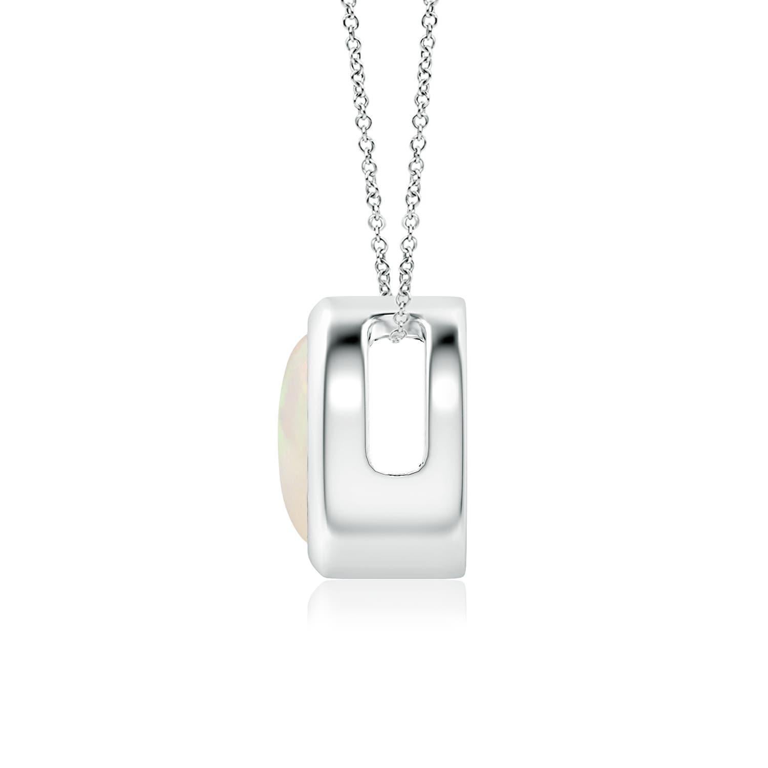The mesmerizing round opal appears to be floating on the chain. It is secured in a platinum bezel setting. This simple yet alluring opal pendant is designed to make an elegant style statement with its stunning play of colors. Available in different