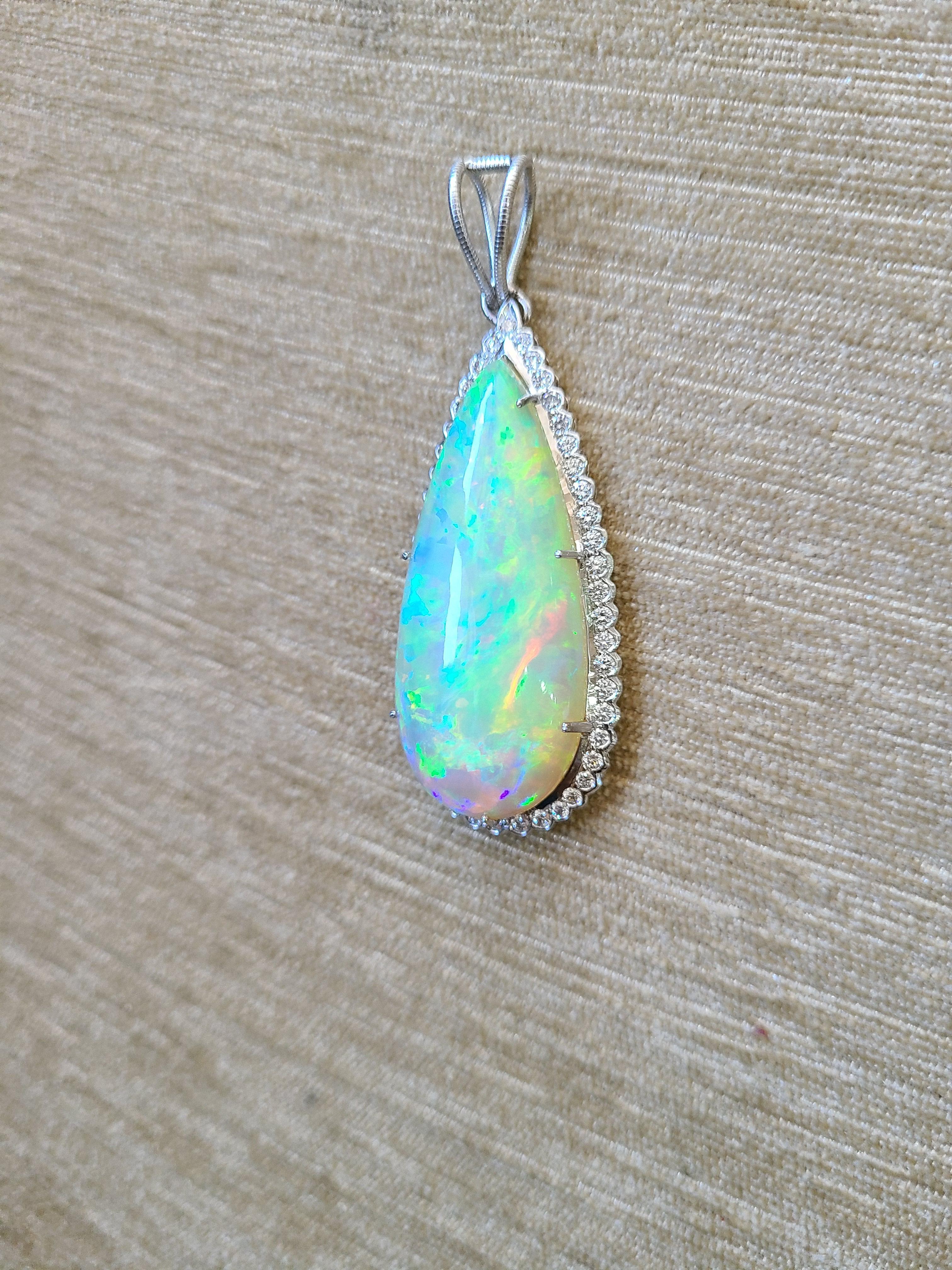 A chic opal pendant set in 18k white gold with diamonds. The natural opal is from Ethiopia and weight is 25.66 carats with diamond weight .78 carats. The pendant dimensions in cm 6 x 2.5 x .7 (LXWXD)