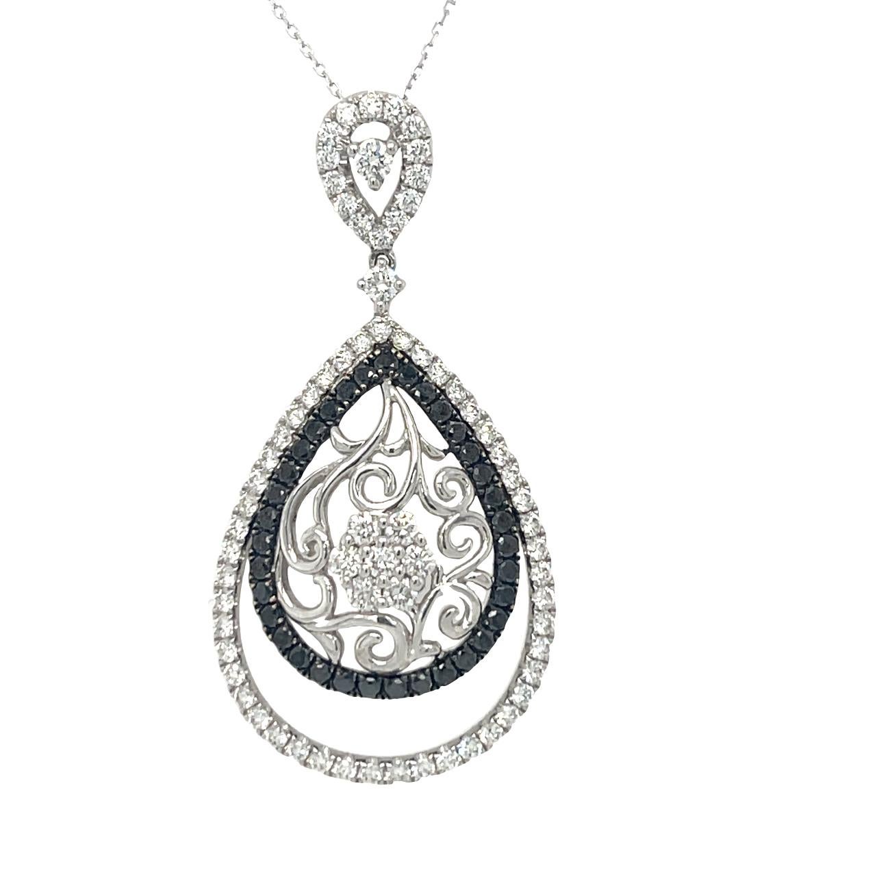 This elegant teardrop pendant has 35 natural black diamonds and 70 brilliant cut white diamonds set in 18K White Gold. White gold chain is included. Pendant has detailed tag attached. This pendant comes in a beautiful box ready for the perfect gift.