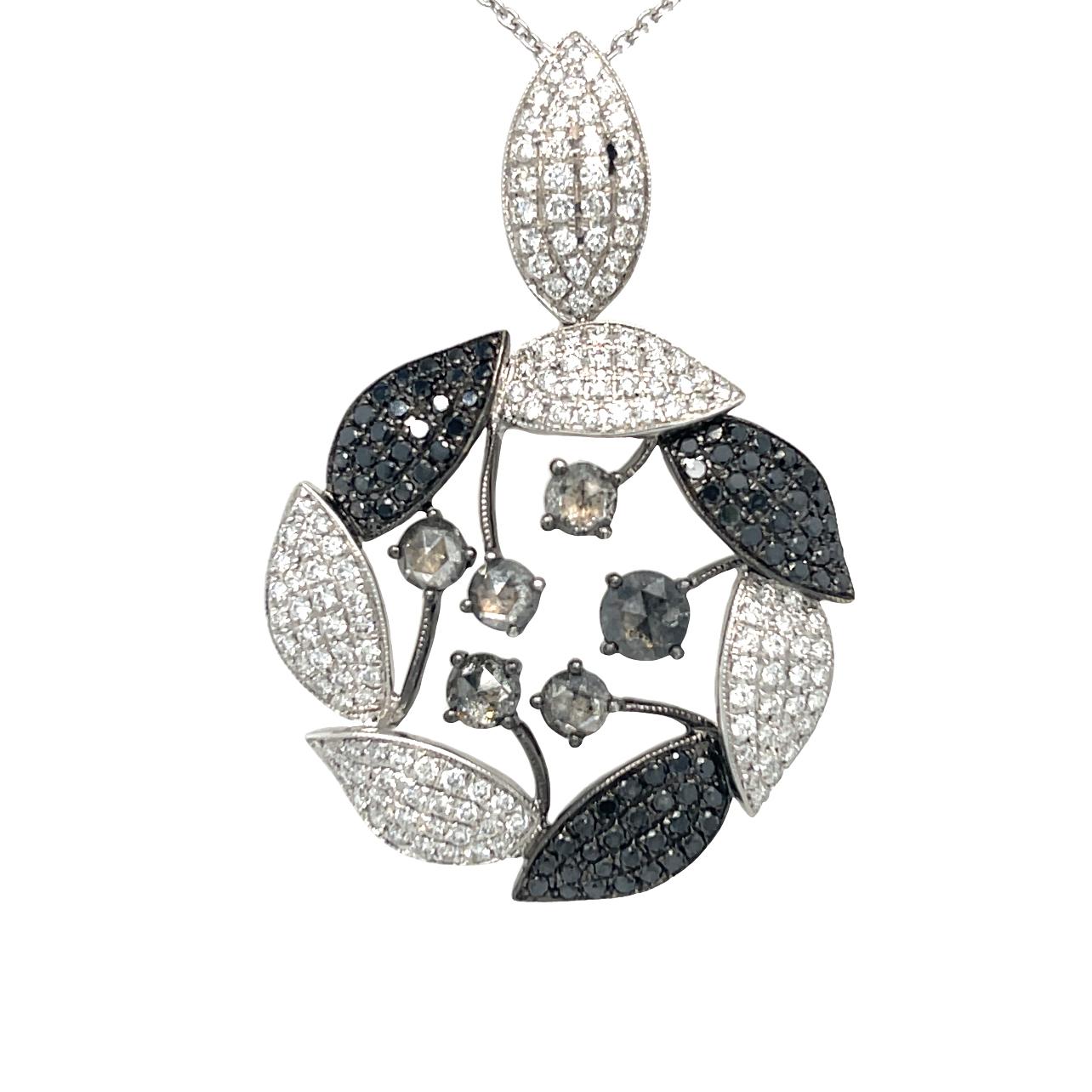 This elegant pendant has fancy colored diamonds set in 18K White Gold. The elegant leaves on this pendant are intertwined to form a beautiful circle with larger colored diamonds suspended in the center. White gold chain is included. Pendant has