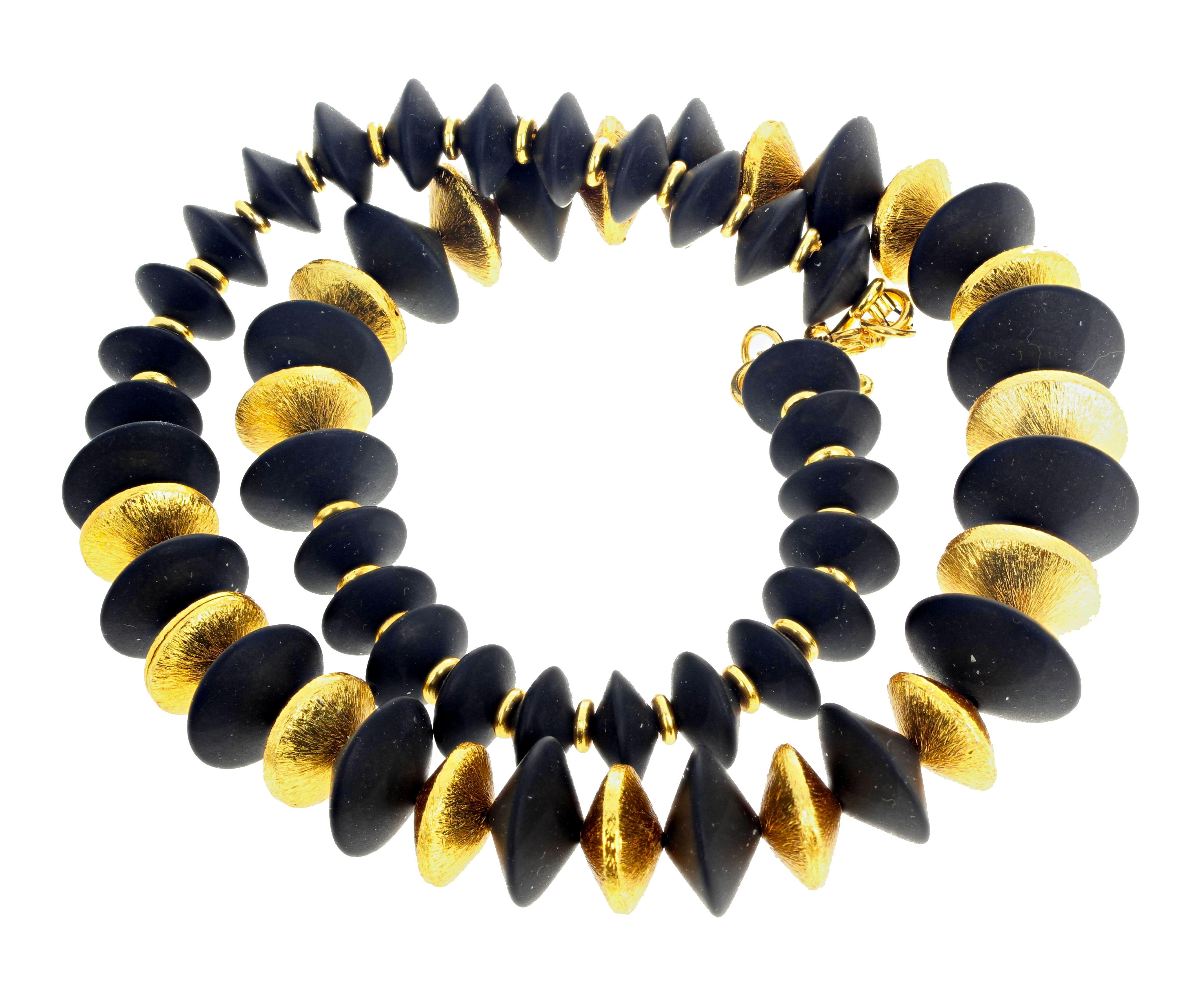 Beautifully cut and finished rondels of natural Black Onyx  enhanced with gold plated sterling silver rondels set in this elegant 20 inch long necklace.  The largest gemstone rondels are approximately 20 mm.  The clasp is an easy to use vermeil