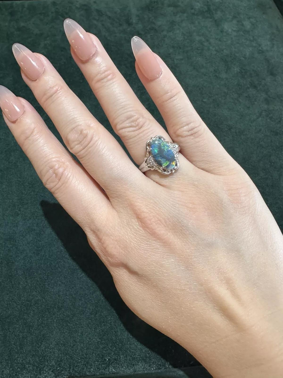 Natural Black Opal and Diamond Ring in Platinum

Black Opal and Diamond Ring features one Natural Oval Cabochon Black Opal weighing 2.36 carats with Blue and Green play of color on a Black background accented with Natural Round Brilliant Diamonds,