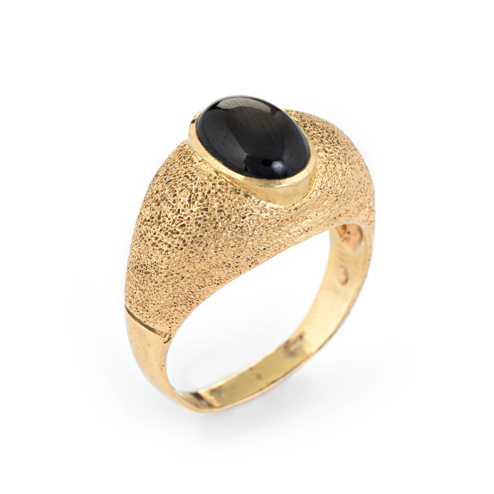 Elegant vintage natural black star sapphire ring (circa 1960s to 1970s), crafted in 14 karat yellow gold. 

The black star sapphire measures 10mm x 7mm (estimated at 2.50 carats). The sapphire is in excellent condition and free of cracks or chips.