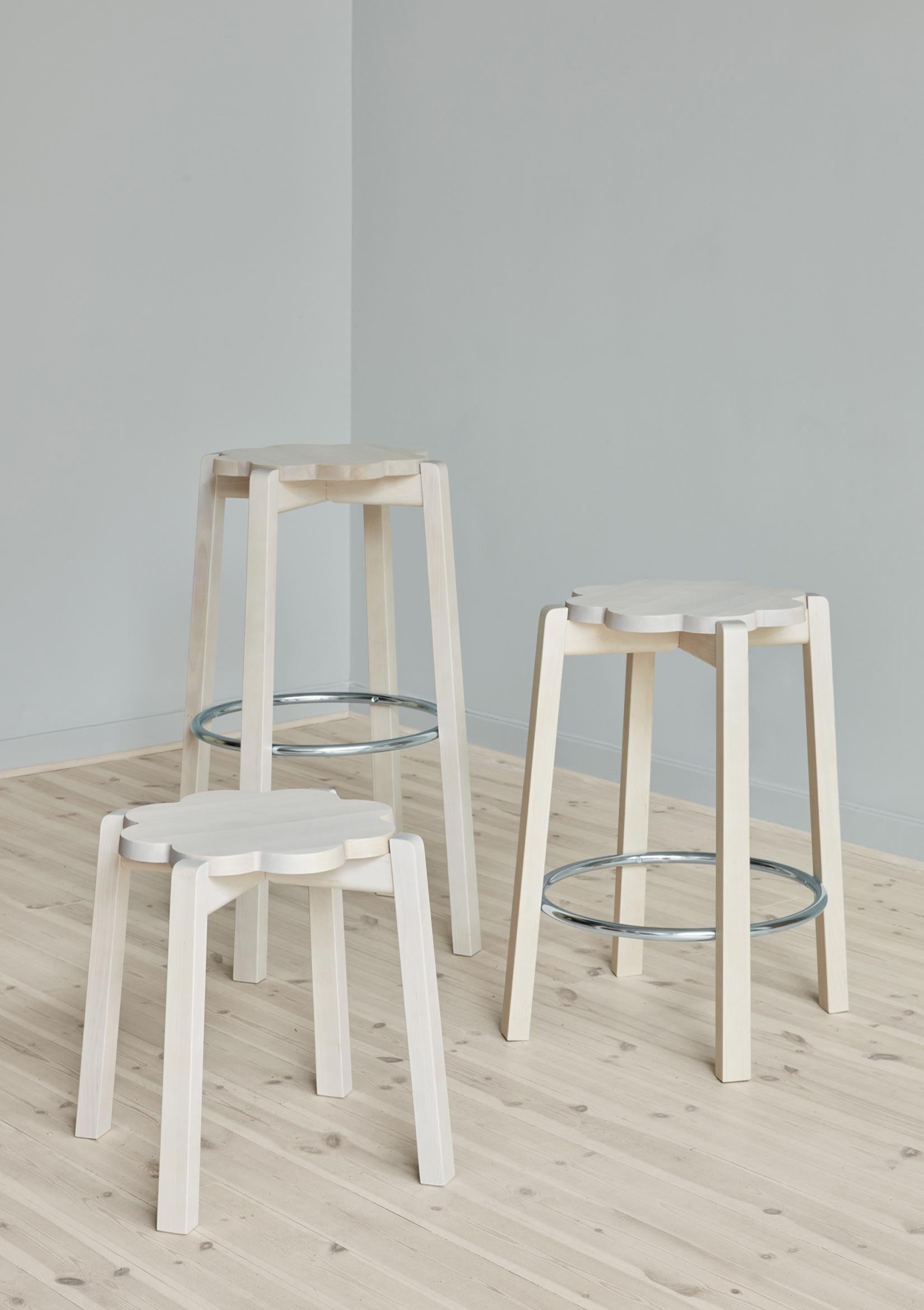 Natural Blossom stool by Storängen Design
Dimensions: D 41 x W 41 x H 45 cm
Materials: birch wood.
Available in other colors and sizes.

A small and neat stackable chair, which works well round tables in cafes and living rooms.
A clean