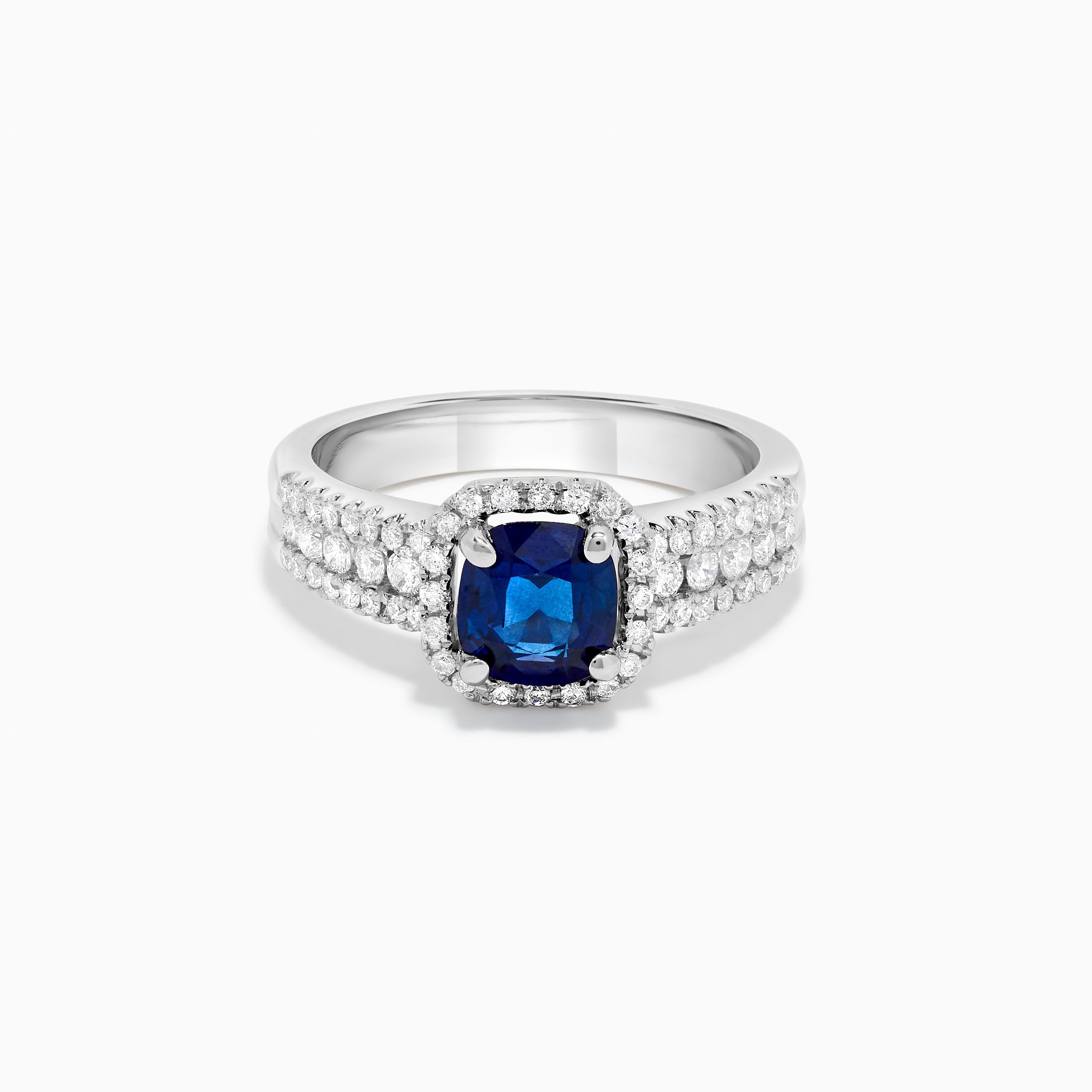 RareGemWorld's classic sapphire ring. Mounted in a beautiful 14K White Gold setting with a natural cushion cut blue sapphire. The sapphire is surrounded by natural round white diamond melee. This ring is guaranteed to impress and enhance your