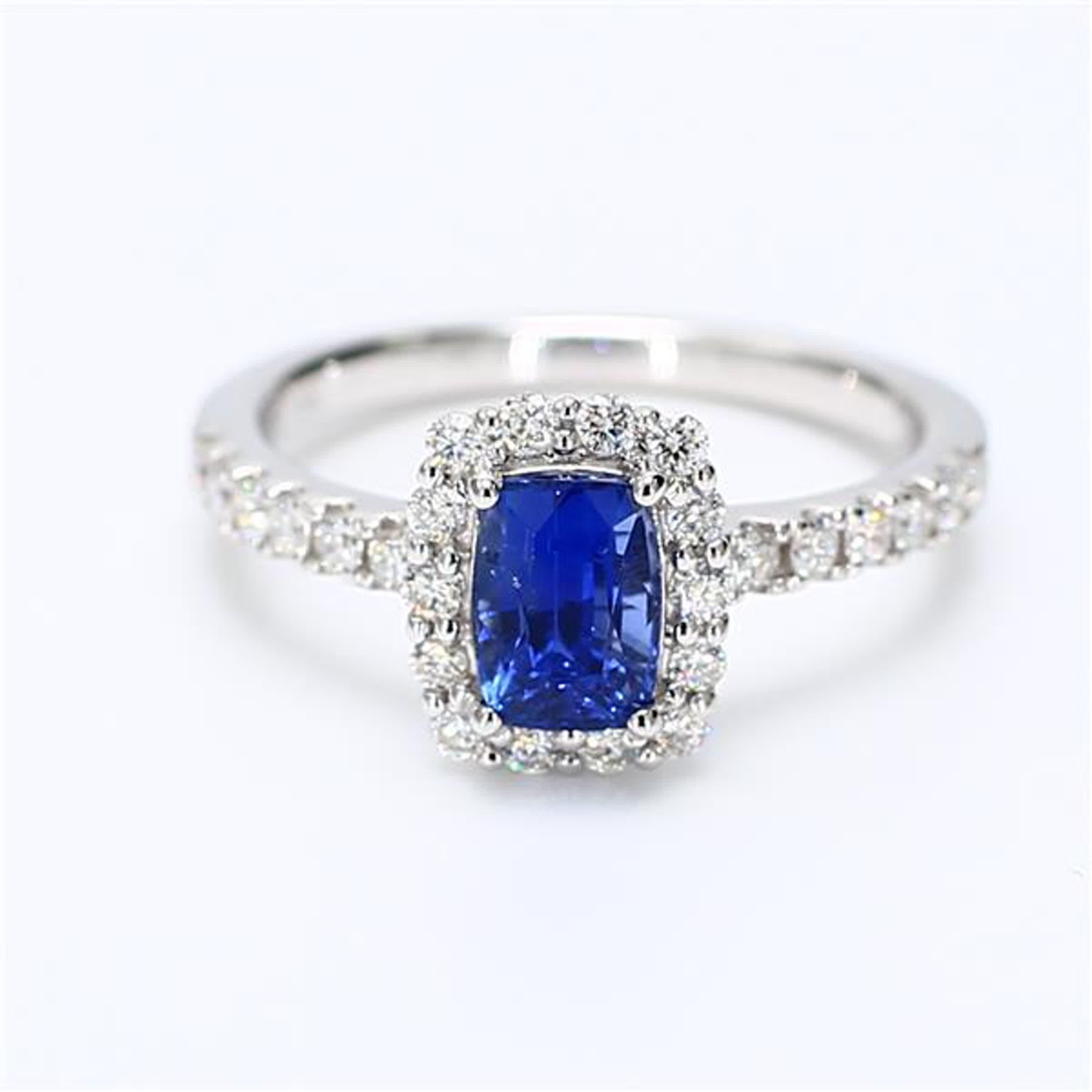 RareGemWorld's classic sapphire ring. Mounted in a beautiful 18K White Gold setting with a natural cushion cut blue sapphire. The sapphire is surrounded by natural round white diamond melee. This ring is guaranteed to impress and enhance your