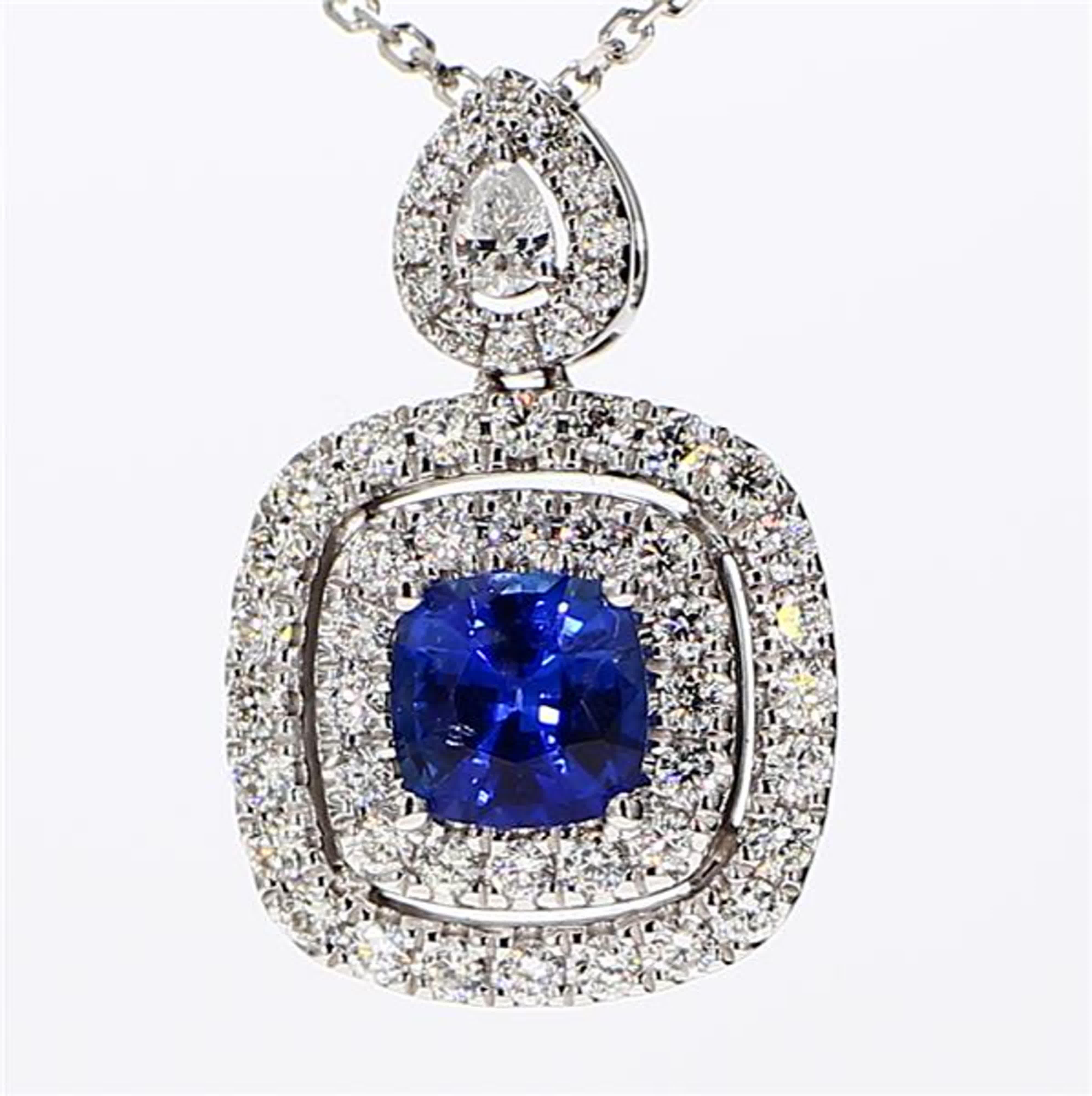 RareGemWorld's classic sapphire pendant. Mounted in a beautiful 18K White Gold setting with a natural cushion cut blue sapphire. The sapphire is surrounded by natural round white diamond melee as well as a natural pear cut white diamond. This