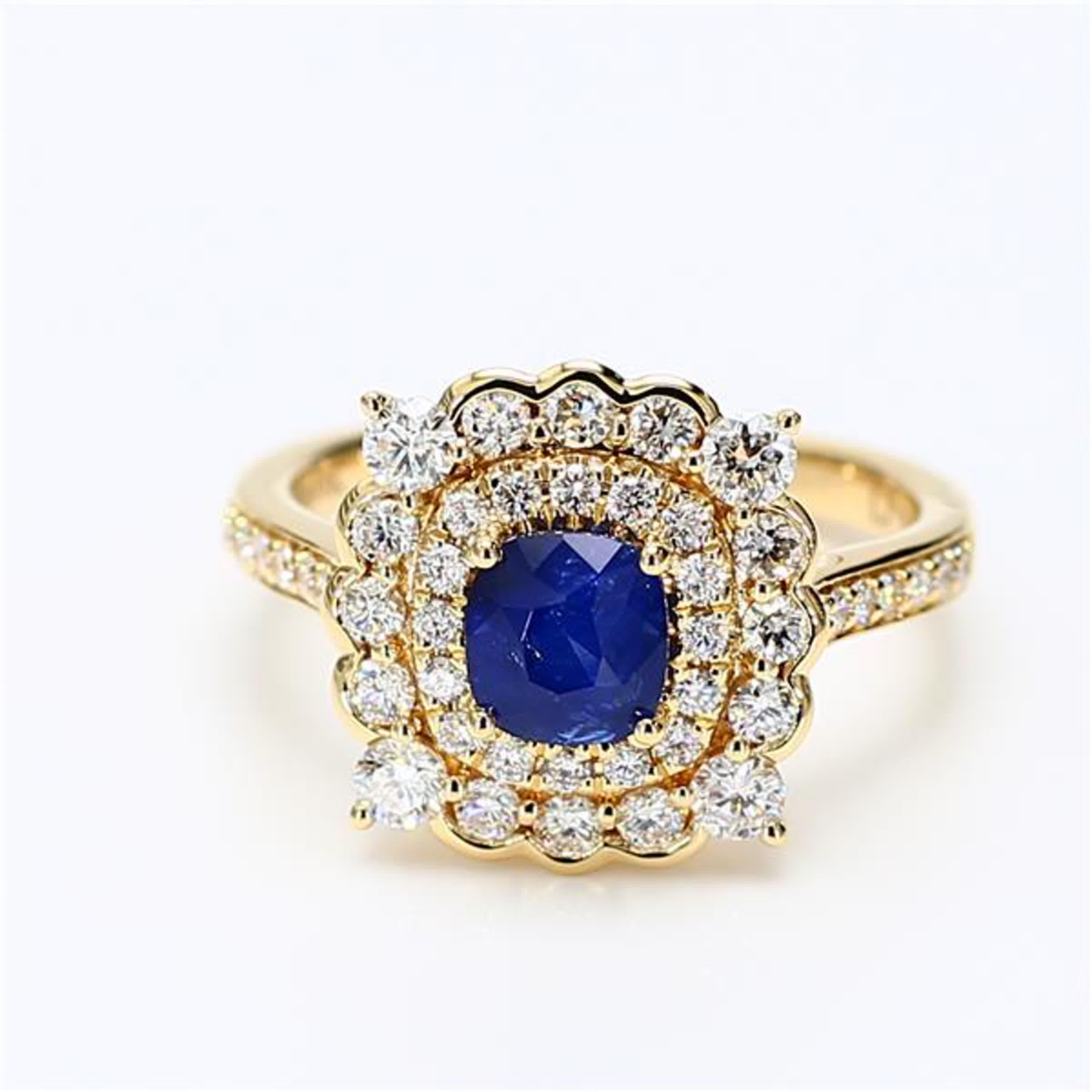 RareGemWorld's classic sapphire ring. Mounted in a beautiful 18K Yellow Gold setting with a natural cushion cut blue sapphire. The sapphire is surrounded by natural round white diamond melee. This ring is guaranteed to impress and enhance your