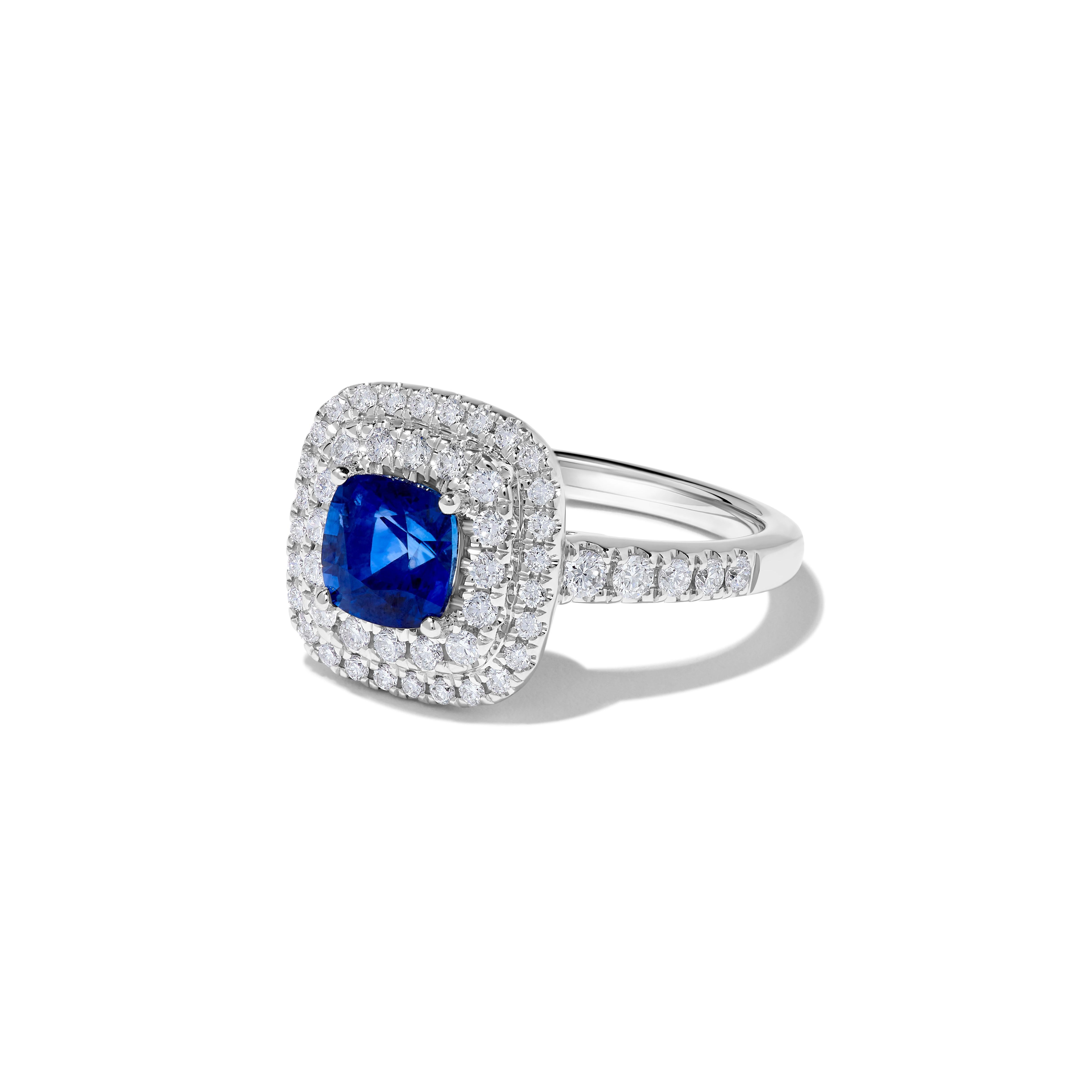RareGemWorld's beautiful sapphire ring. Mounted in a beautiful 18K White Gold setting with a natural cushion cut blue sapphire. The sapphire is surrounded by natural round white diamond melee. This ring is guaranteed to impress and enhance your