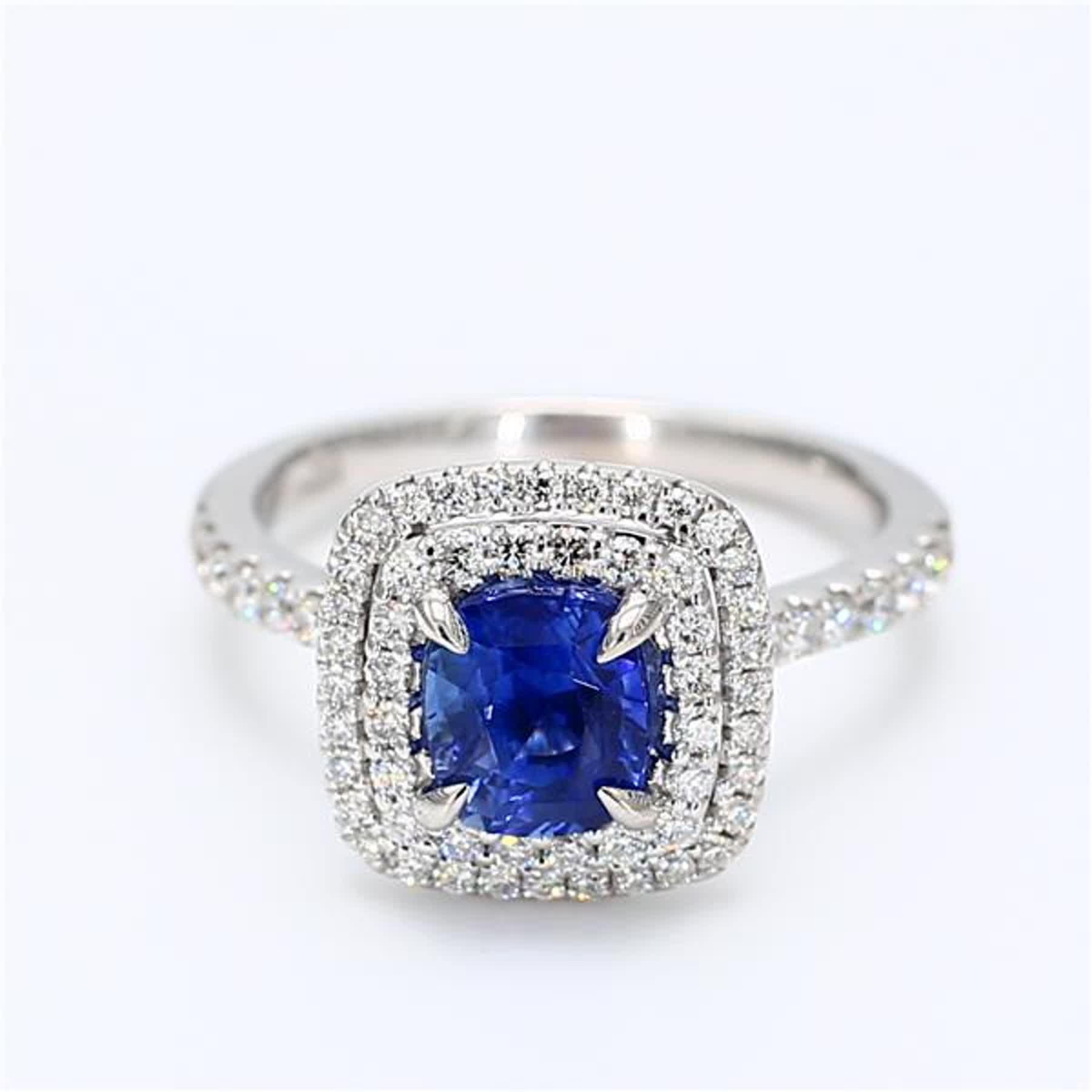 RareGemWorld's classic natural cushion cut sapphire ring. Mounted in a beautiful 18K White Gold setting with a natural cushion cut blue sapphire. The sapphire is surrounded by natural round white diamond melee. This ring is guaranteed to impress and