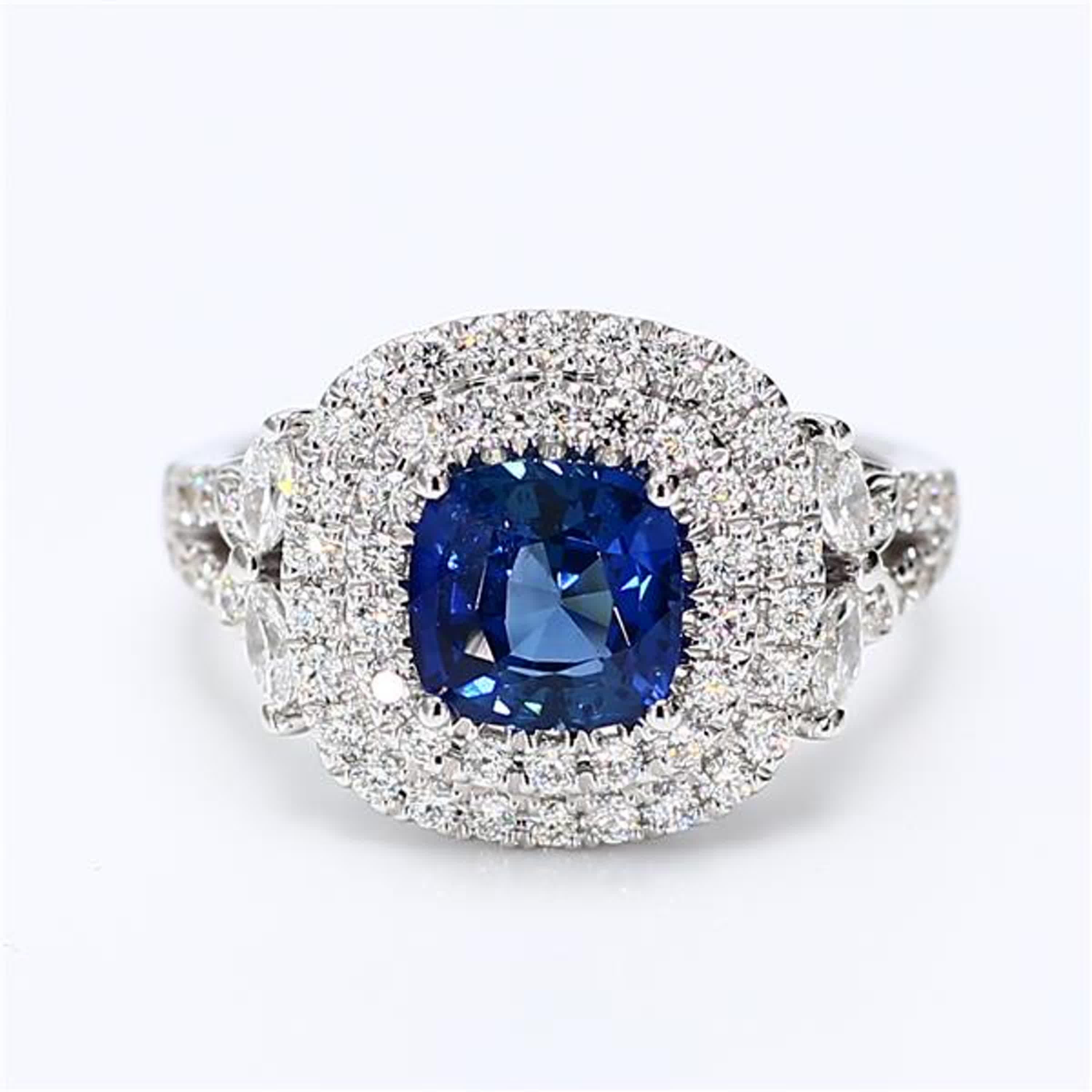 RareGemWorld's classic sapphire ring. Mounted in a beautiful 18K White Gold setting with a natural cushion cut blue sapphire. The sapphire is surrounded by natural marquise cut white diamonds and natural round white diamond melee. This ring is