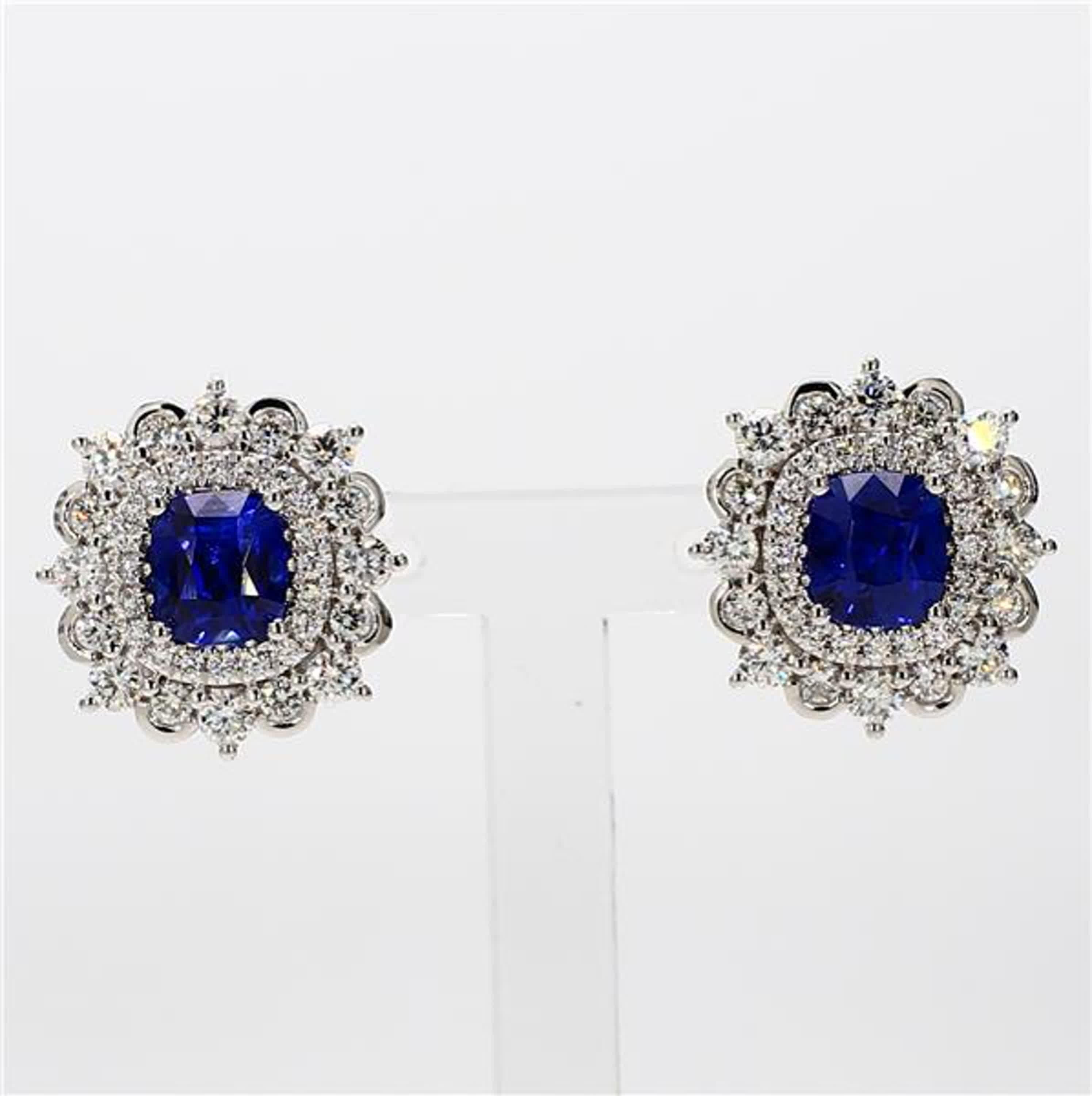 RareGemWorld's classic sapphire earrings. Mounted in a beautiful 18K White Gold setting with natural cushion cut blue sapphires. The sapphires are surrounded by natural round white diamond melee. These earrings are guaranteed to impress and enhance