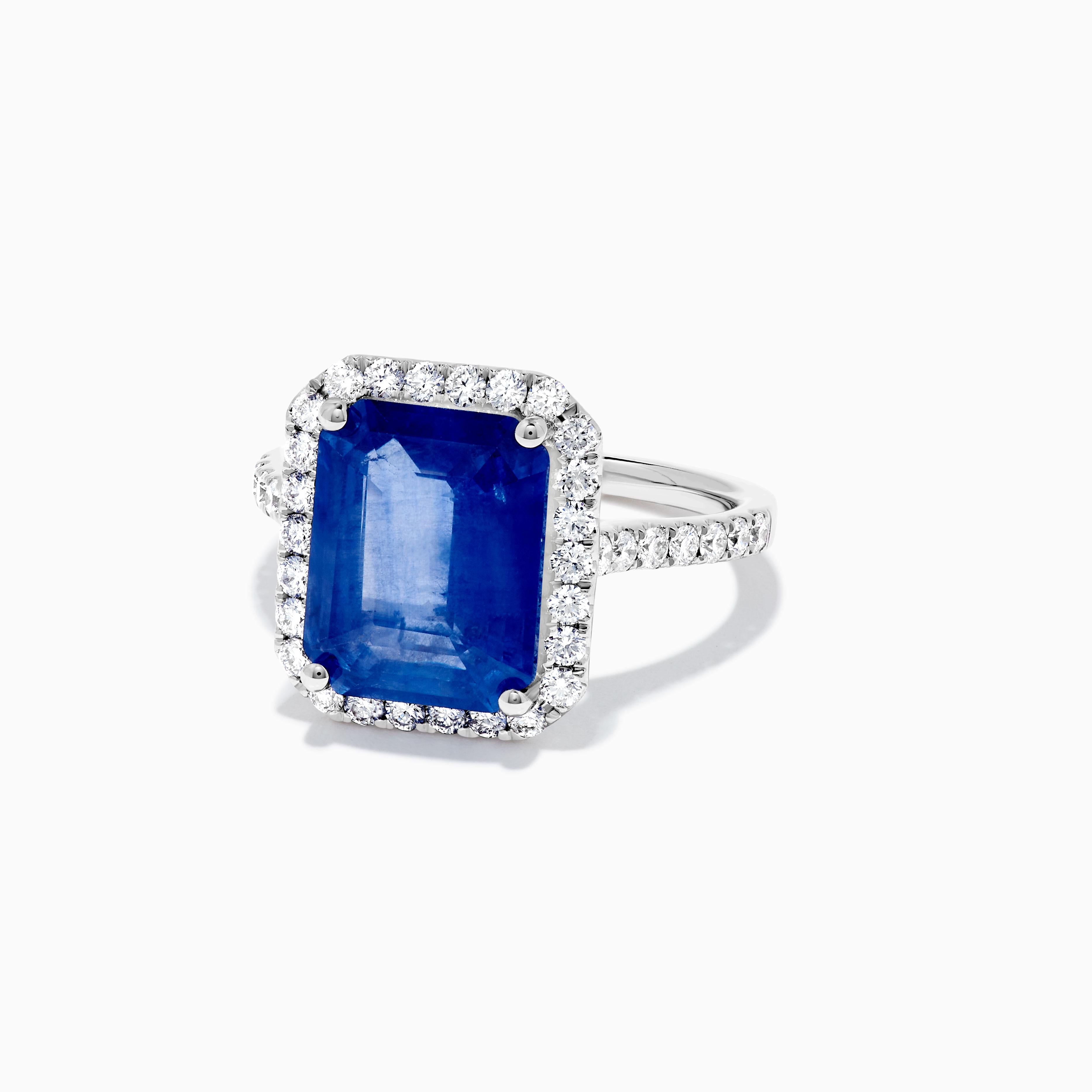 RareGemWorld's classic sapphire ring. Mounted in a beautiful 18K White Gold setting with a natural emerald cut blue sapphire. The sapphire is surrounded by natural round white diamond melee. This ring is guaranteed to impress and enhance your