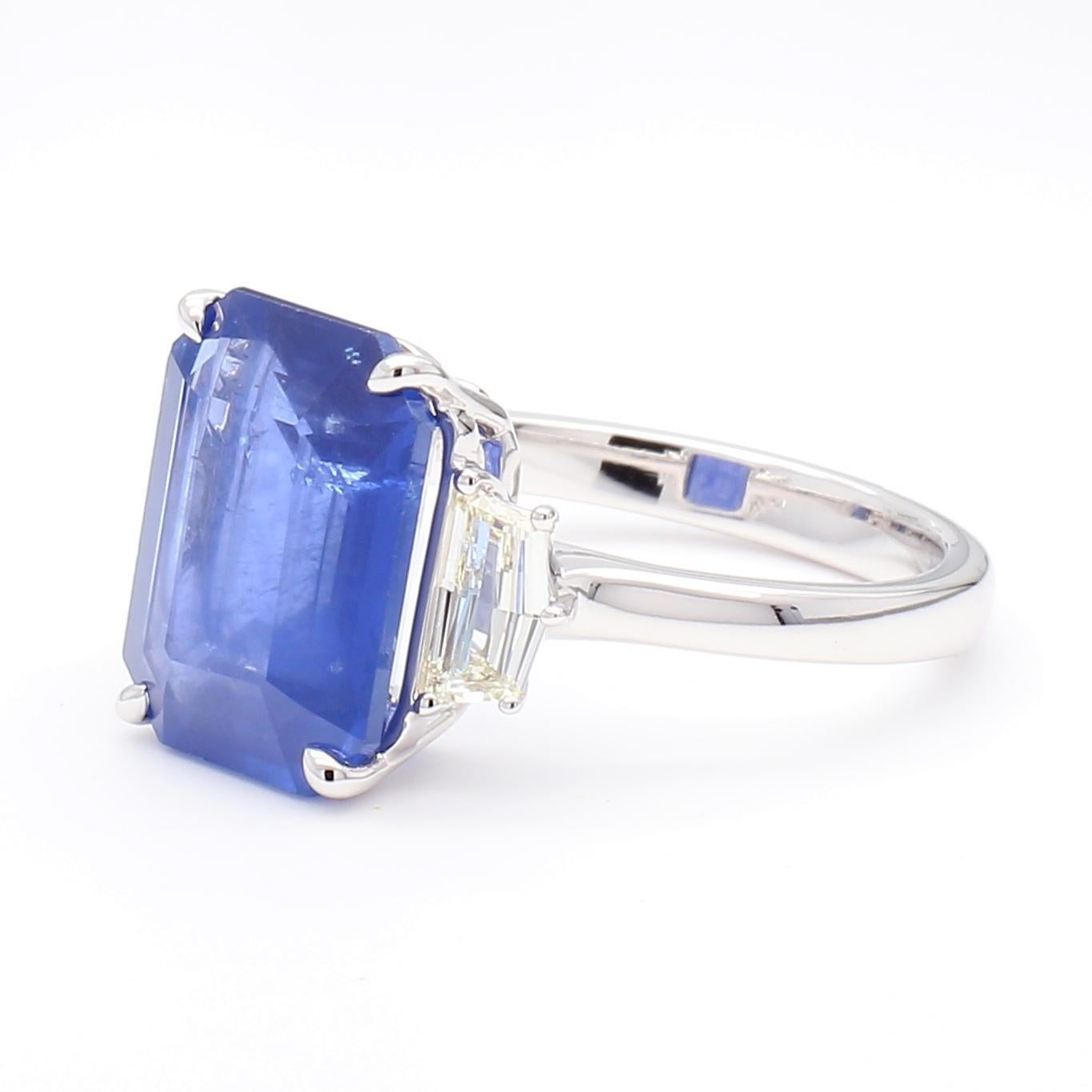 RareGemWorld's beautiful sapphire ring. Mounted in a beautiful 18K White Gold setting with a natural emerald cut blue sapphire. The sapphire is surrounded by two GIA certified natural shield cut white diamonds. This ring is guaranteed to impress and