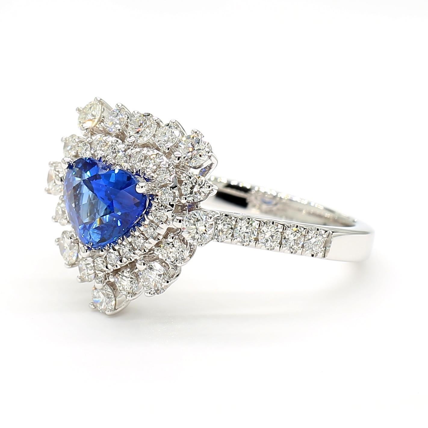 Der schöne Saphirring von RareGemWorld. Montiert in einer schönen Fassung aus 18 Karat Weißgold mit einem natürlichen blauen Saphir im Herzschliff. Die Saphire sind von natürlichen runden weißen Diamanten umgeben. Dieser Ring wird Sie garantiert