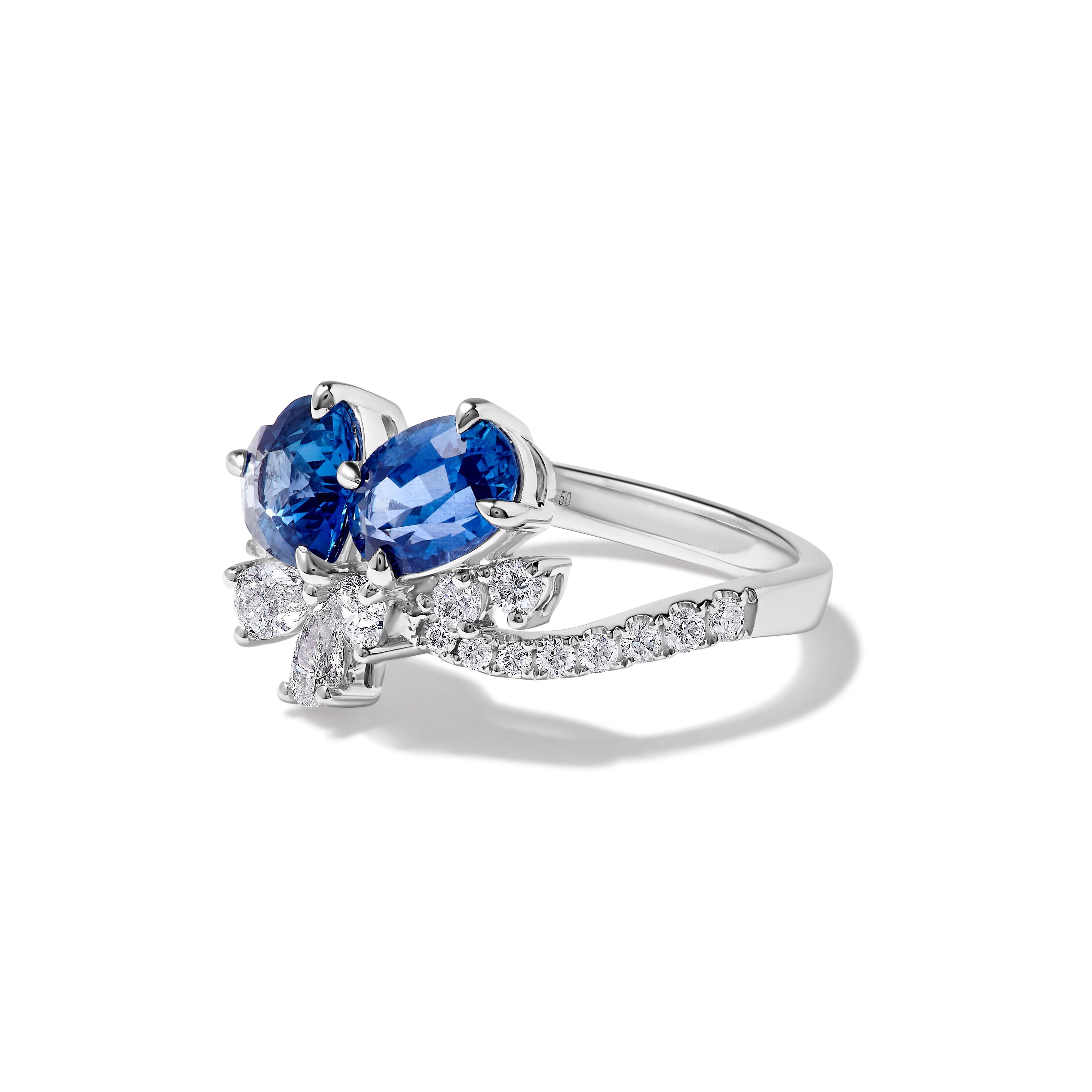 RareGemWorld's beautiful sapphire ring. Mounted in a beautiful 18K White Gold setting with a natural heart cut blue sapphire and natural oval cut blue sapphire. The sapphires are surrounded by natural round white diamond melee. This ring is