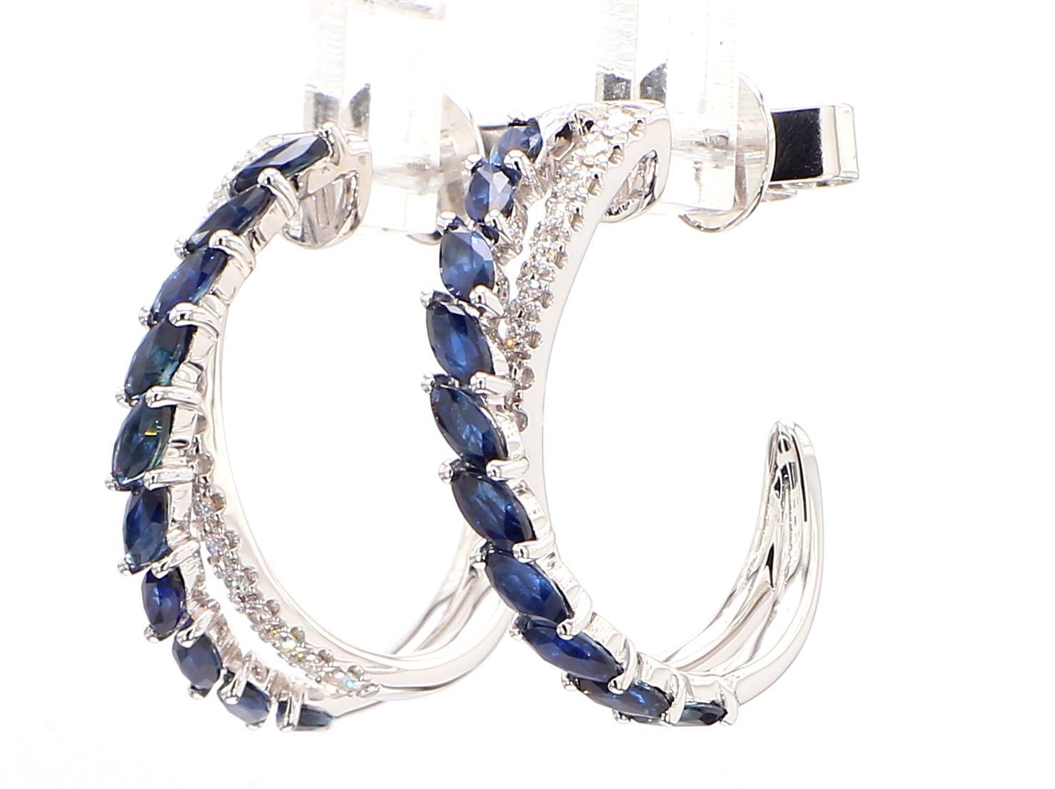 RareGemWorld's classic sapphire earrings. Mounted in a beautiful 18K White Gold setting with natural marquise cut blue sapphires complimented by natural round white diamond melee. These earrings are guaranteed to impress and enhance your personal