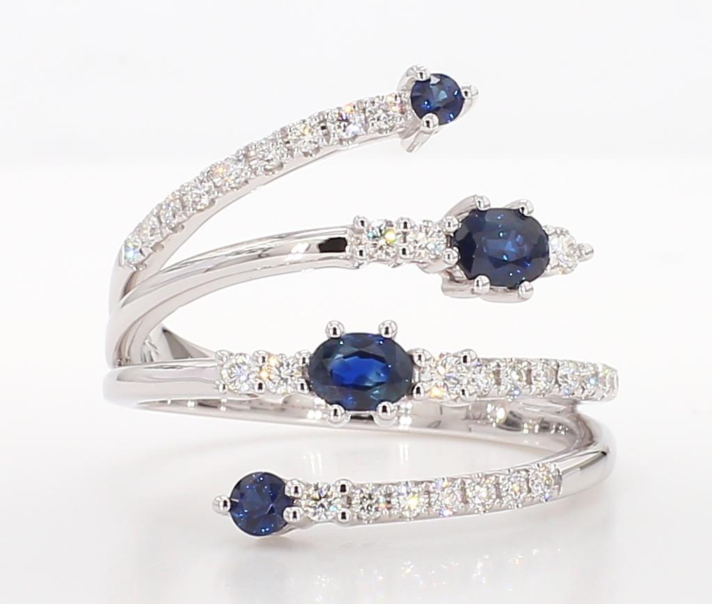 Contemporary Natural Blue Oval Sapphire and White Diamond 0.90 Carat TW Gold Cocktail Ring For Sale