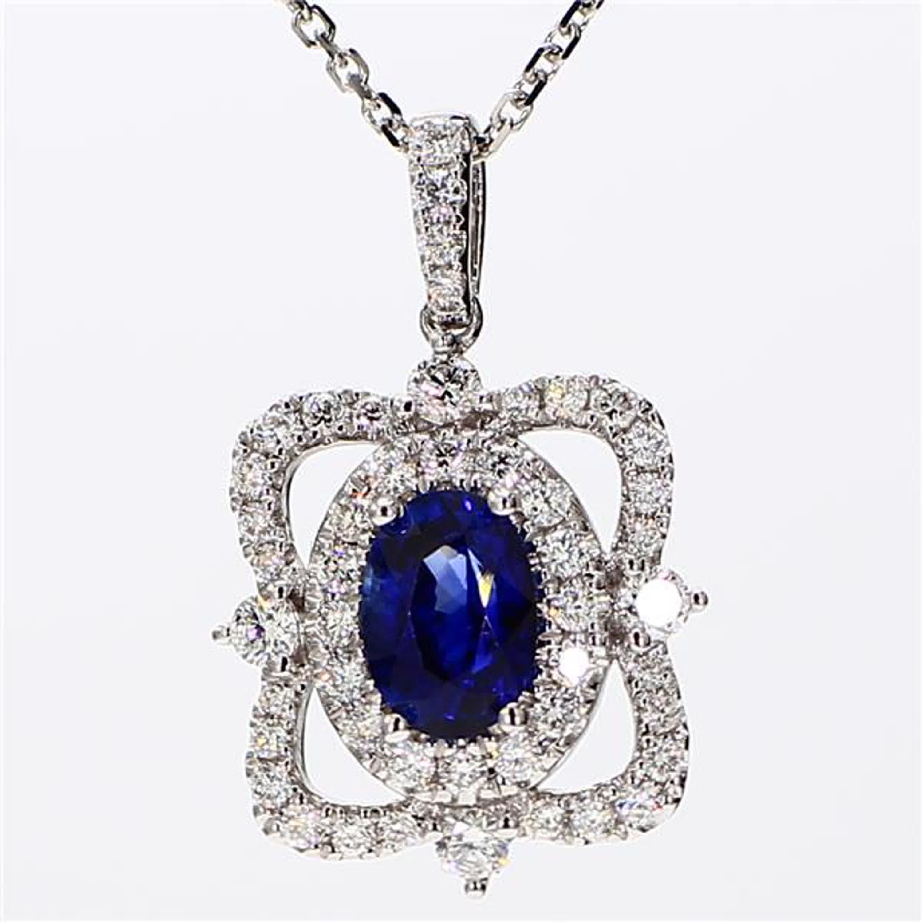RareGemWorld's classic sapphire pendant. Mounted in a beautiful 18K White Gold setting with a natural oval cut blue sapphire. The sapphire is surrounded by natural round white diamond melee. This pendant is guaranteed to impress and enhance your