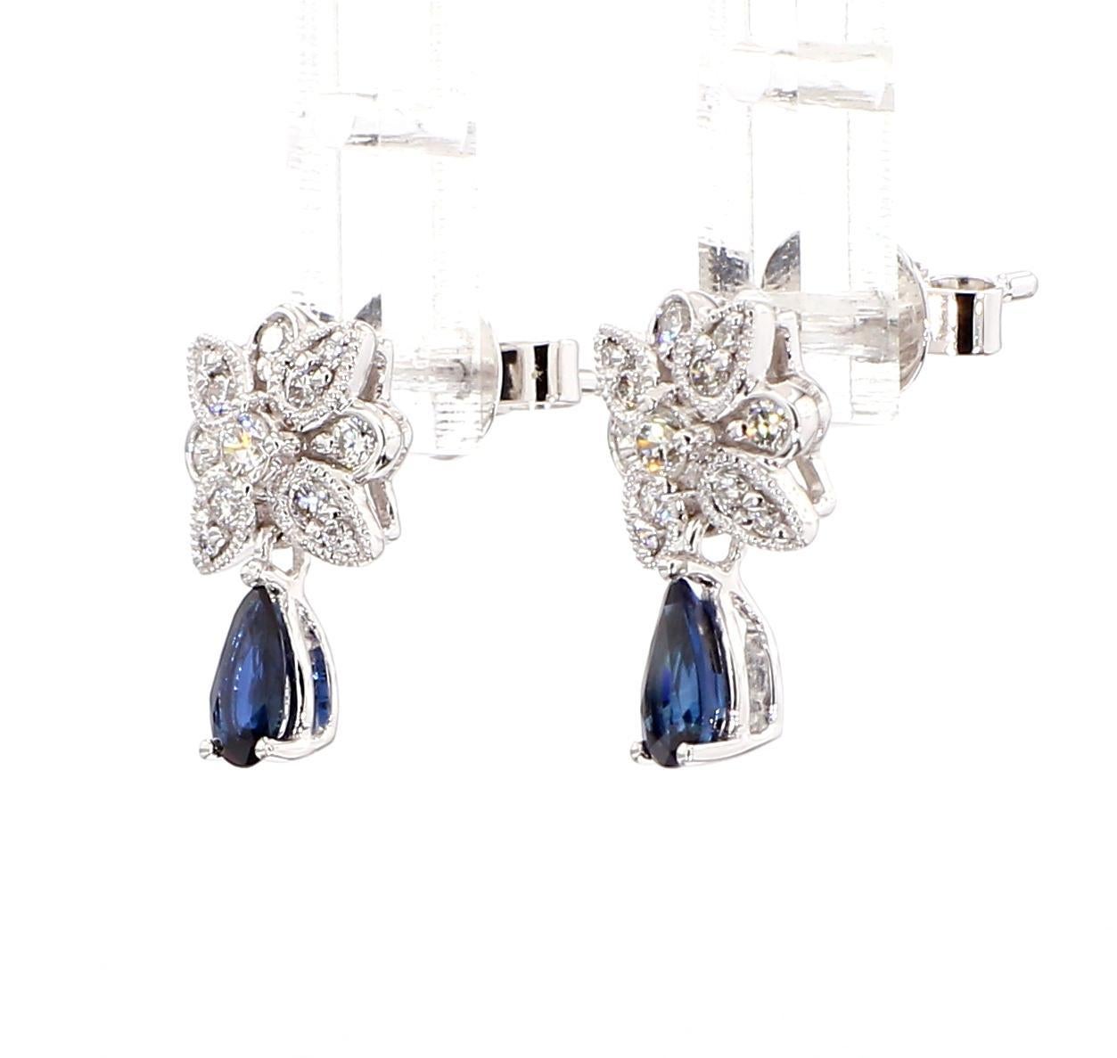 RareGemWorld's beautiful sapphire earrings. Mounted in a beautiful 14K White Gold setting with natural pear cut blue sapphires. The sapphires are surrounded by natural round white diamond melee. These earrings are guaranteed to impress and enhance
